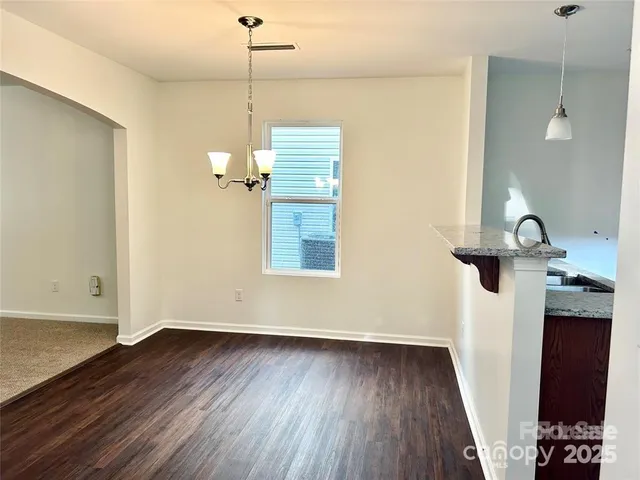 a view of a room with wooden floor and staircase