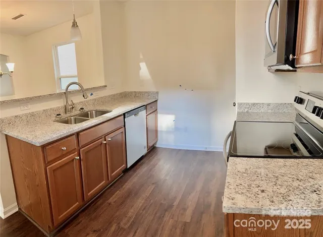a kitchen with a sink and a refrigerator