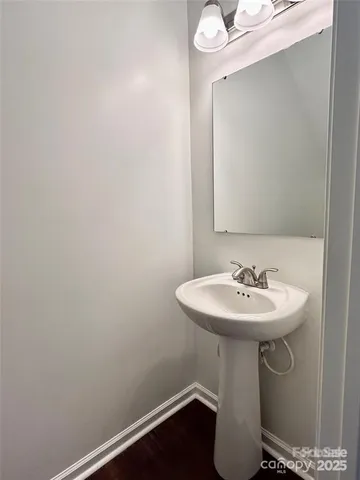 a bathroom with a sink a mirror and vanity