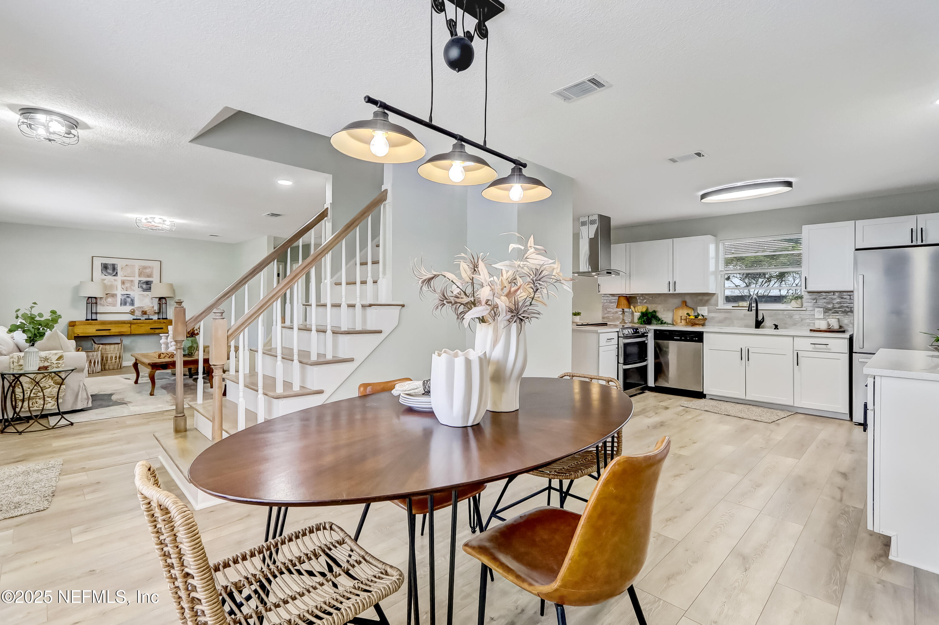 a dining room with furniture and wooden floor