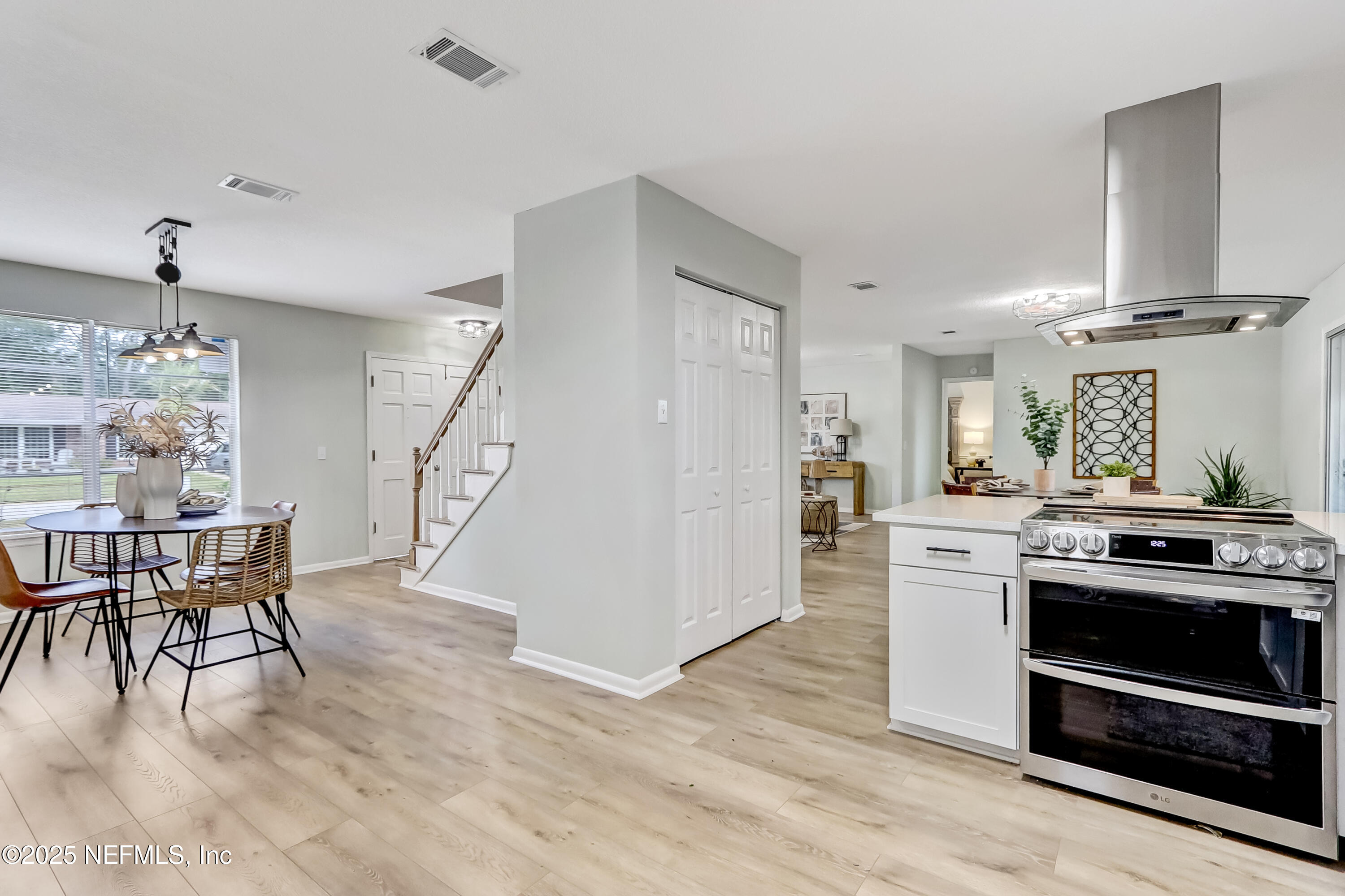 8837 Runnymeade Road Jacksonville, FL 32257 - Photo 19 of 55 a kitchen with stainless steel appliances granite countertop a stove and a wooden floors