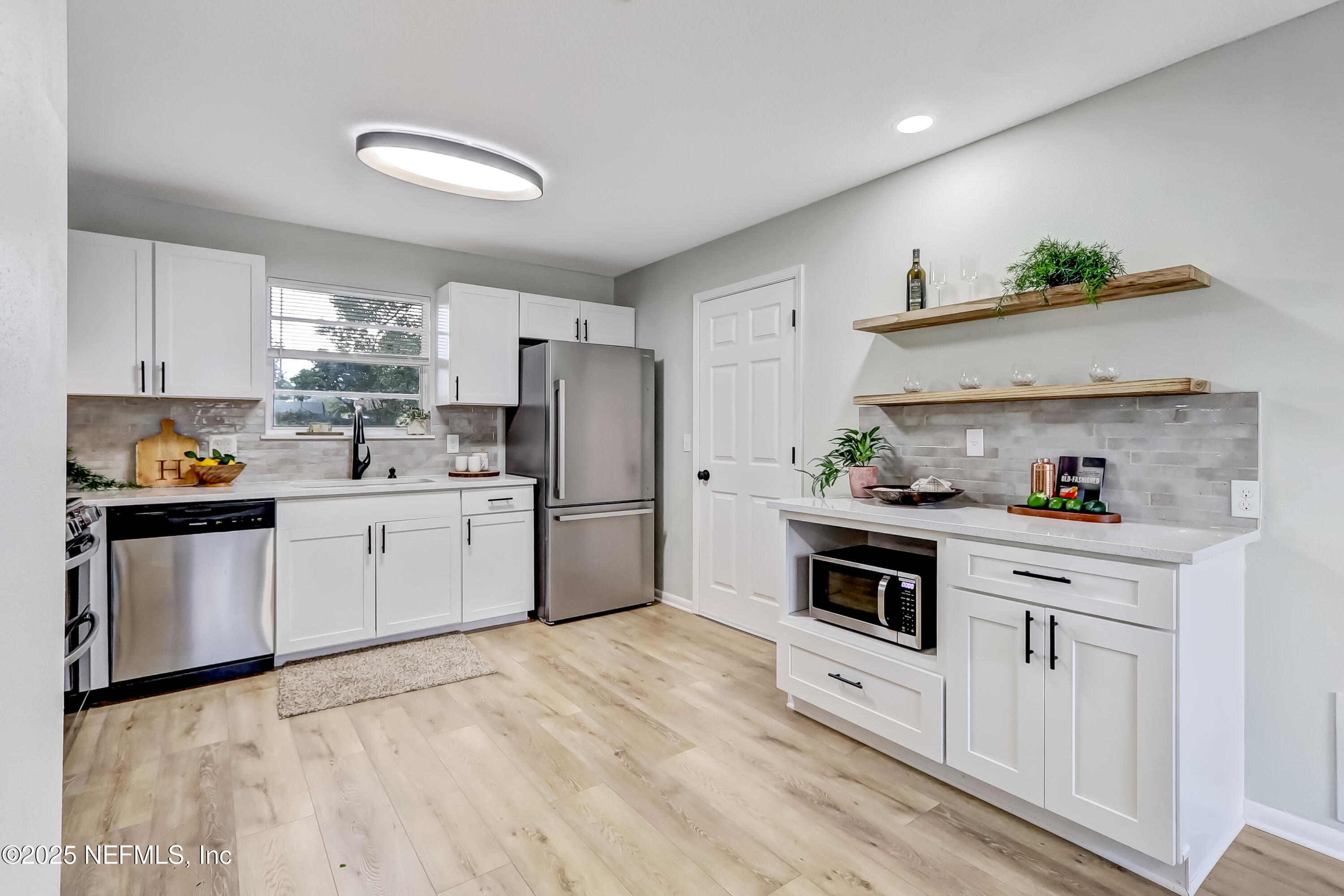 8837 Runnymeade Road Jacksonville, FL 32257 - Photo 21 of 55 a kitchen with white cabinets and white appliances