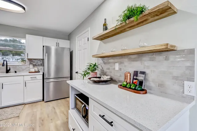 a kitchen with a stove and cabinets