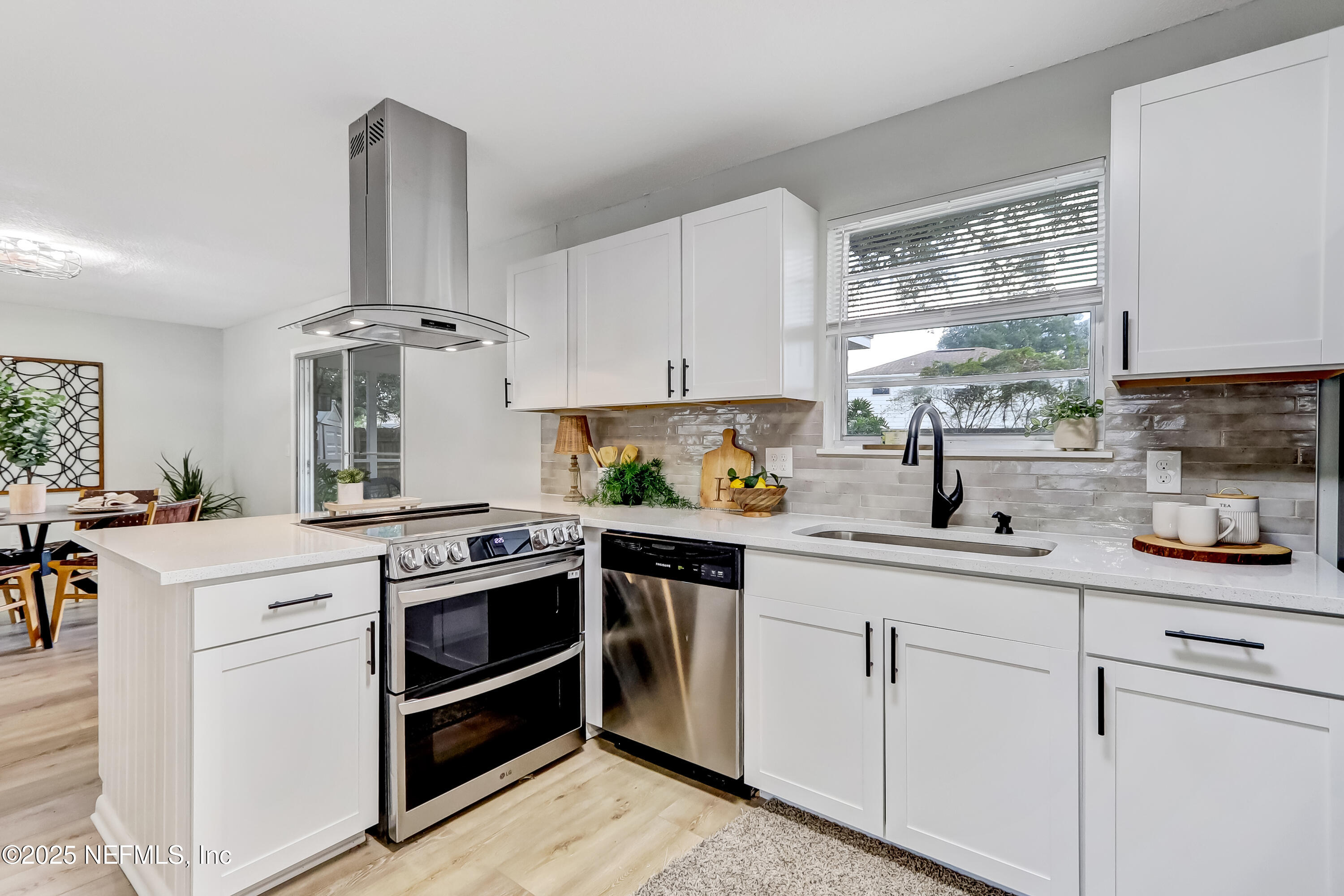 8837 Runnymeade Road Jacksonville, FL 32257 - Photo 23 of 55 a kitchen with appliances a sink and cabinets