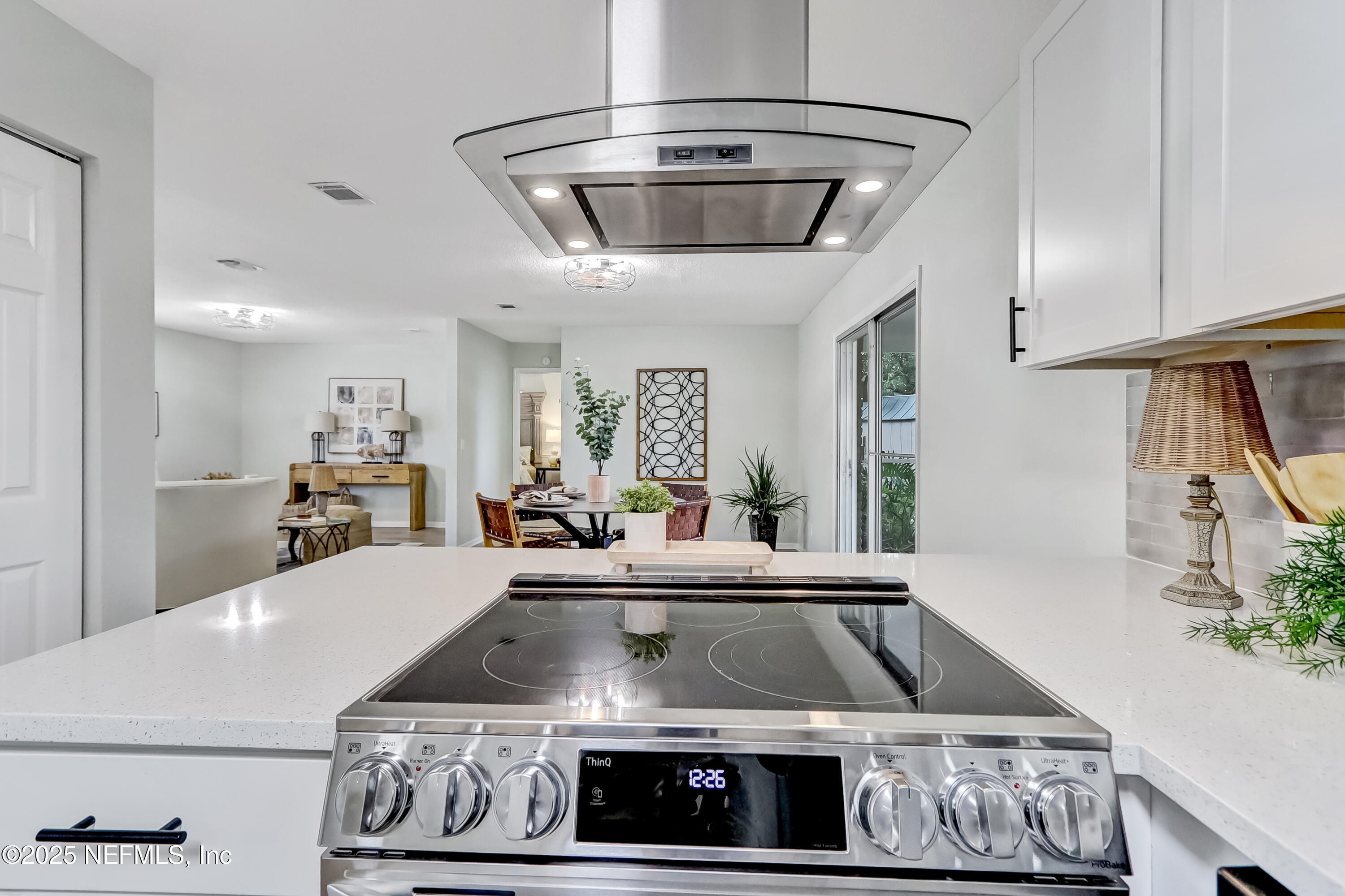 8837 Runnymeade Road Jacksonville, FL 32257 - Photo 24 of 55 a kitchen with a stove and cabinets