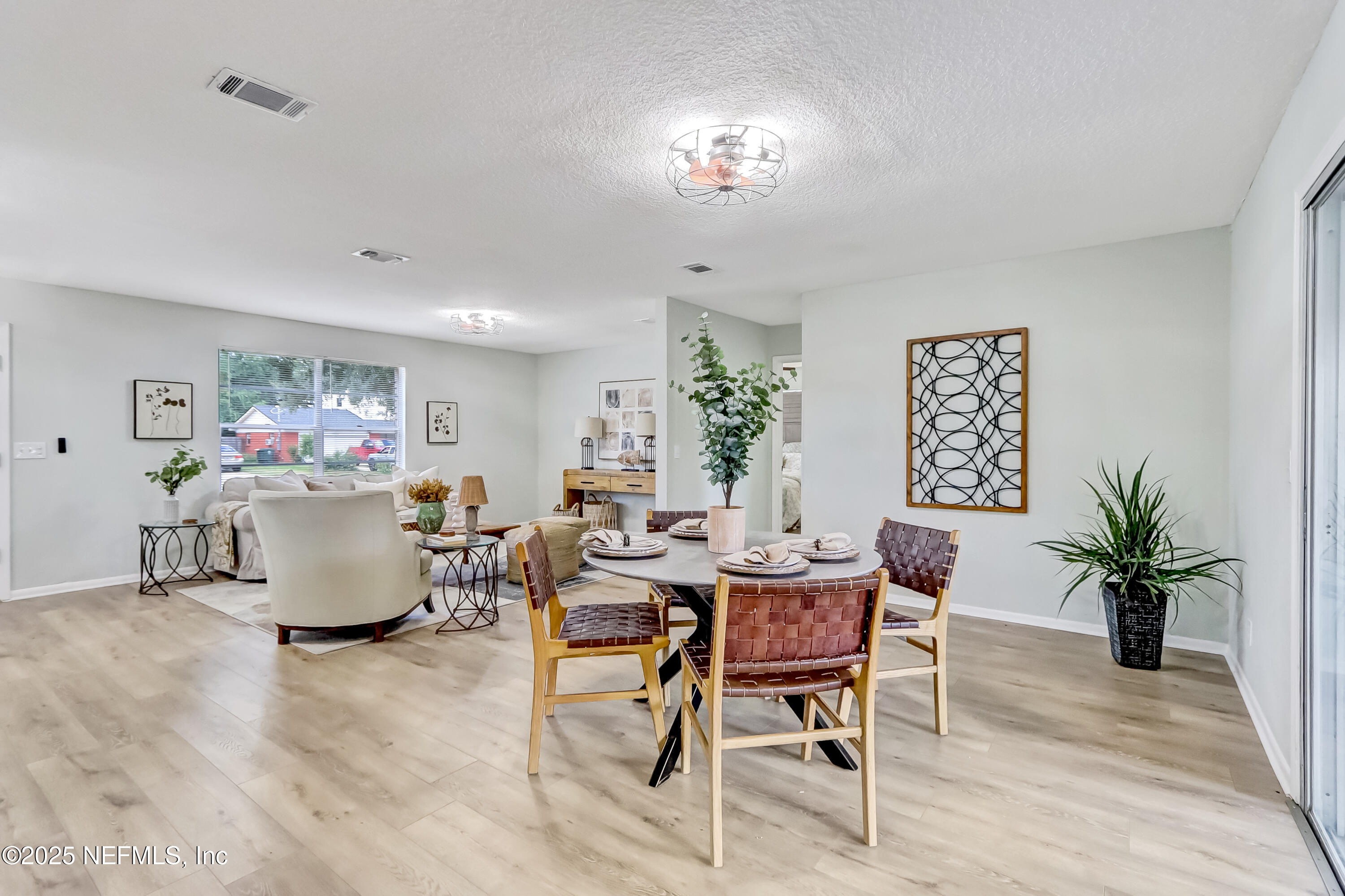8837 Runnymeade Road Jacksonville, FL 32257 - Photo 26 of 55 a living room with furniture and a potted plant