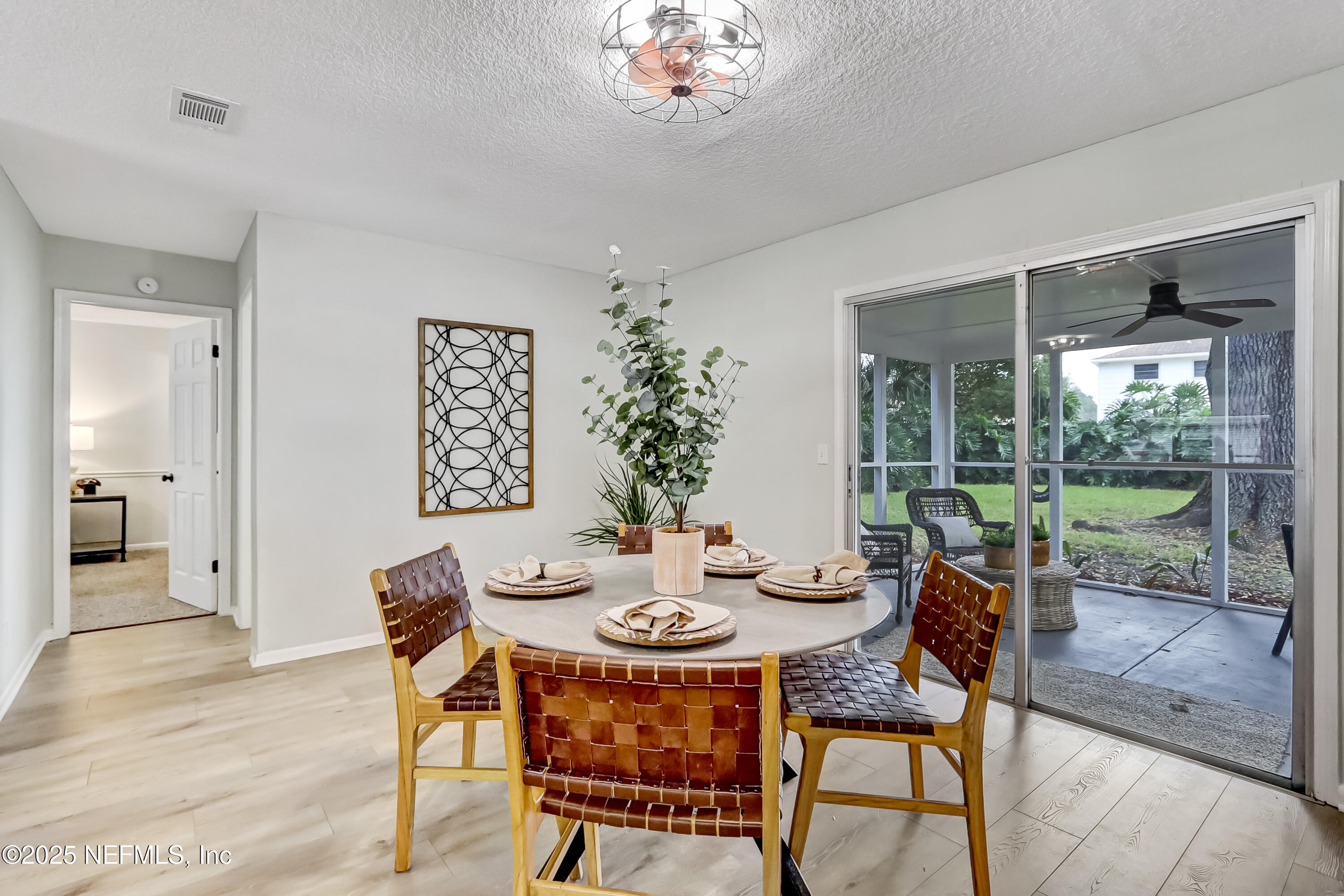 8837 Runnymeade Road Jacksonville, FL 32257 - Photo 27 of 55 a dining room with furniture a rug and a floor to ceiling window