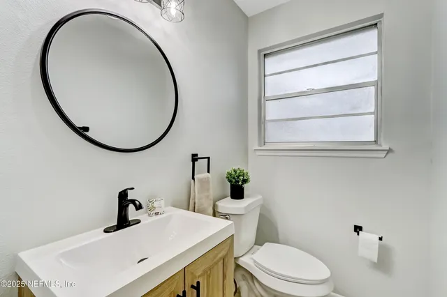 a bed room with a bed and a ceiling fan