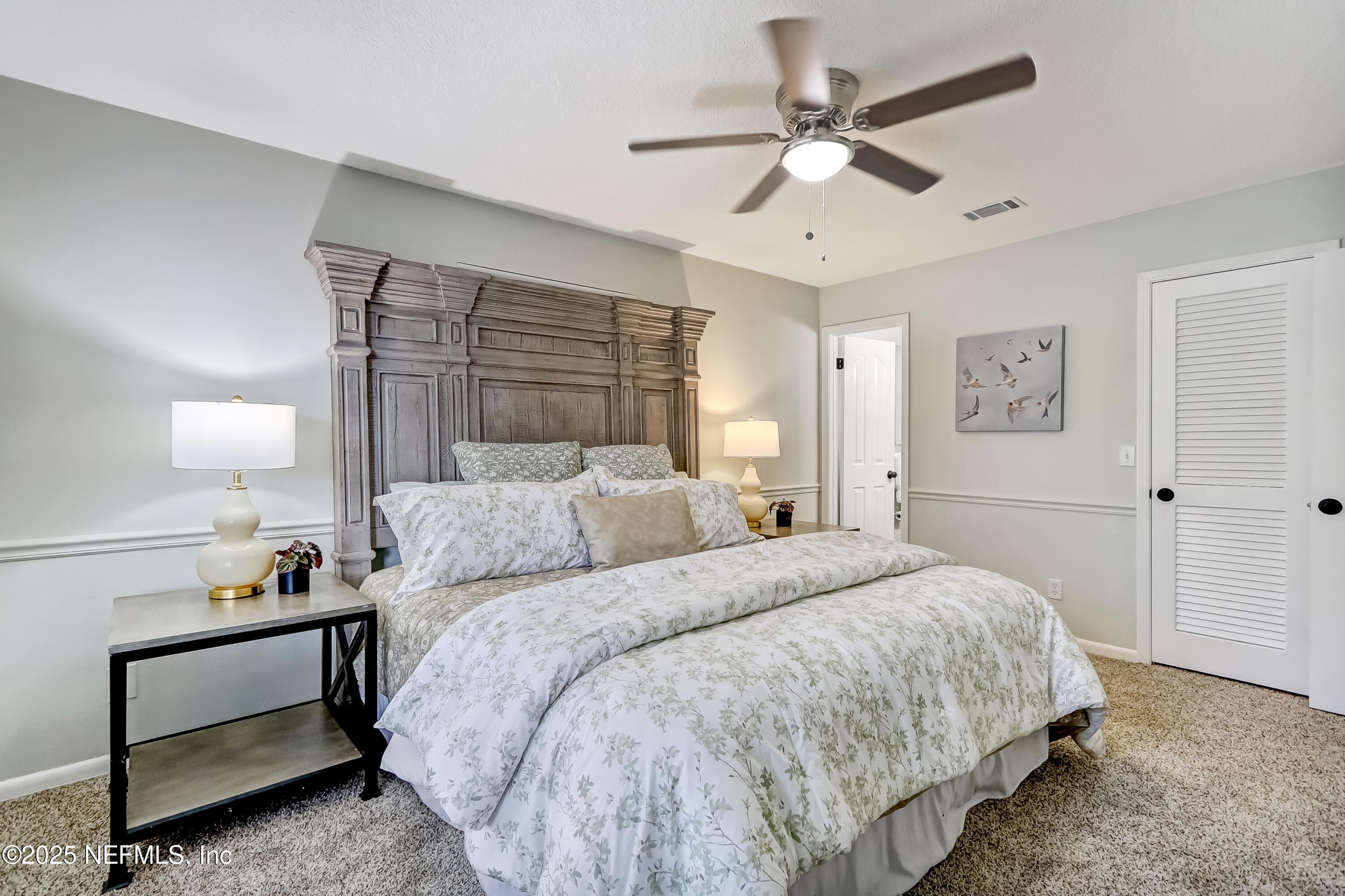 8837 Runnymeade Road Jacksonville, FL 32257 - Photo 32 of 55 a bed room with a bed and a ceiling fan