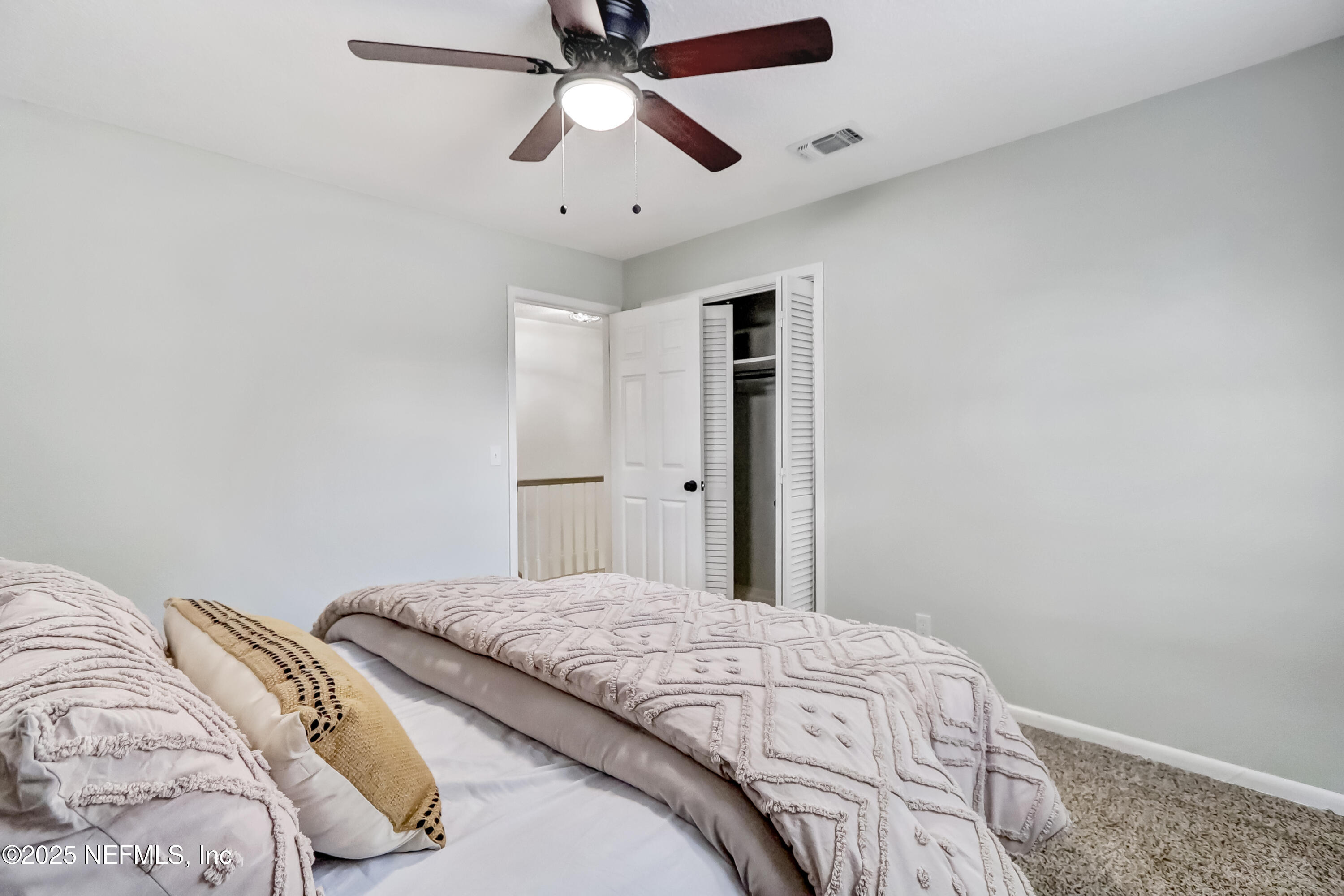 8837 Runnymeade Road Jacksonville, FL 32257 - Photo 38 of 55 a bedroom with a large bed and a chandelier