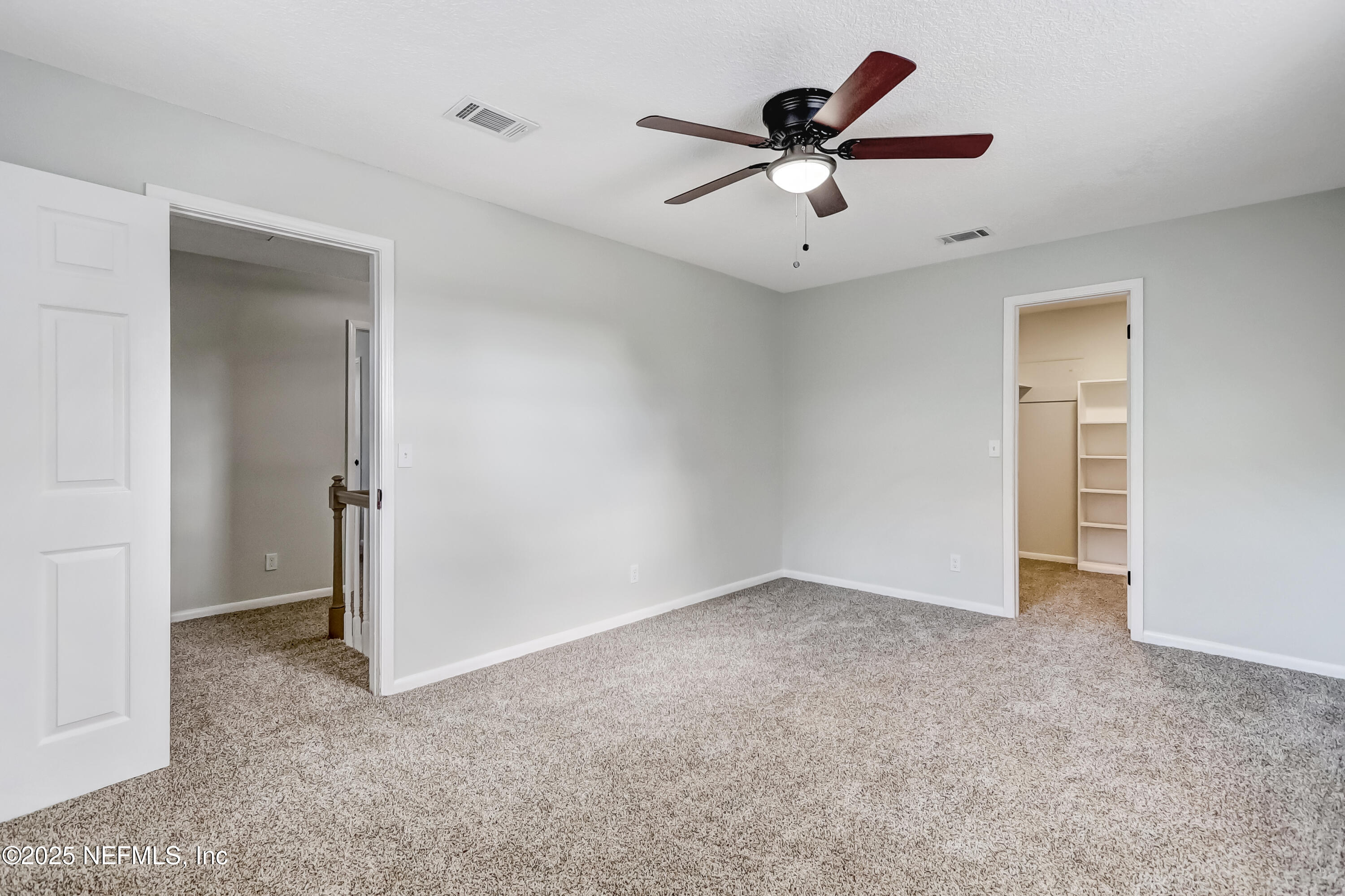 8837 Runnymeade Road Jacksonville, FL 32257 - Photo 45 of 55 an empty room with closet and a ceiling fan
