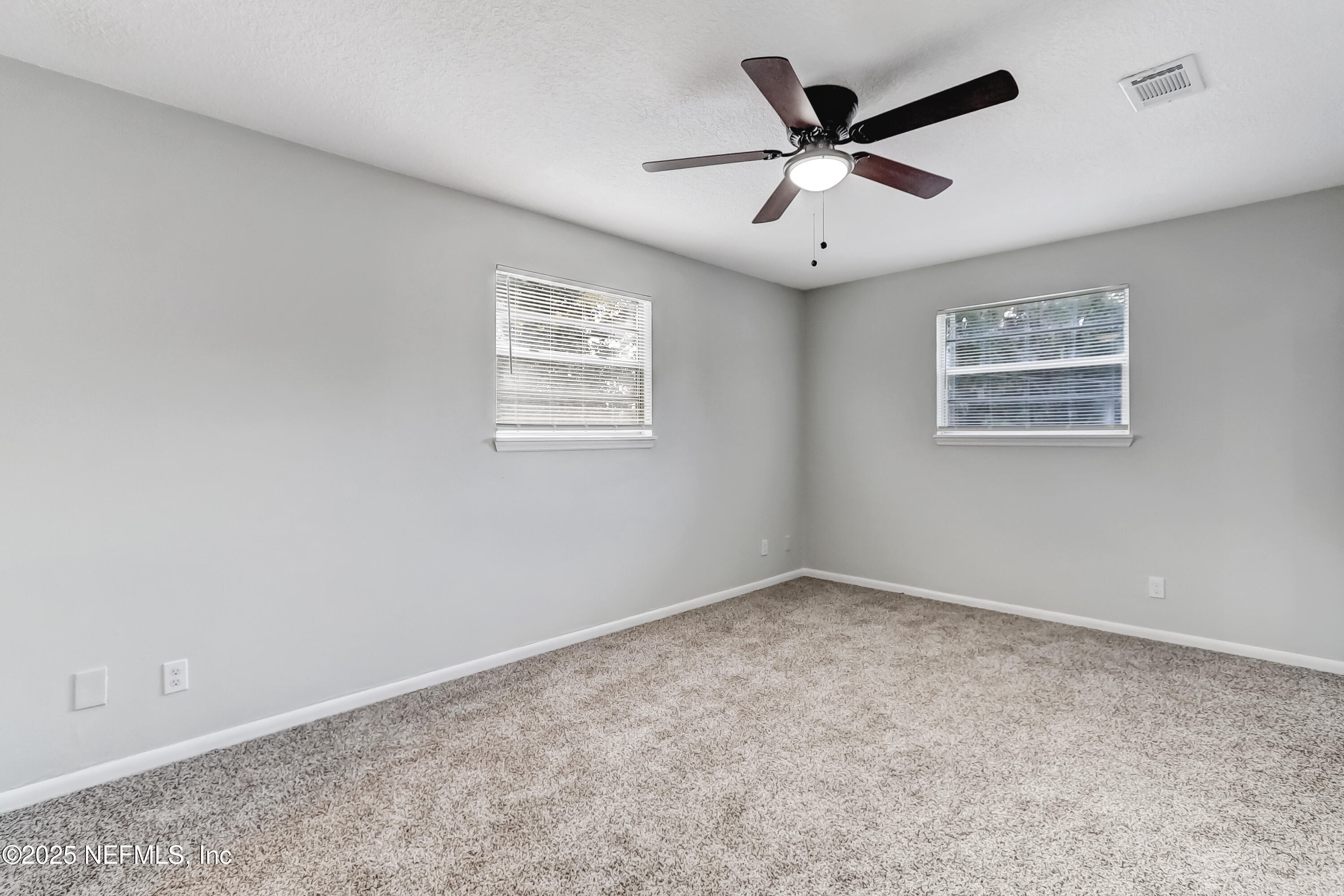 8837 Runnymeade Road Jacksonville, FL 32257 - Photo 47 of 55 an empty room with ceiling fan and window