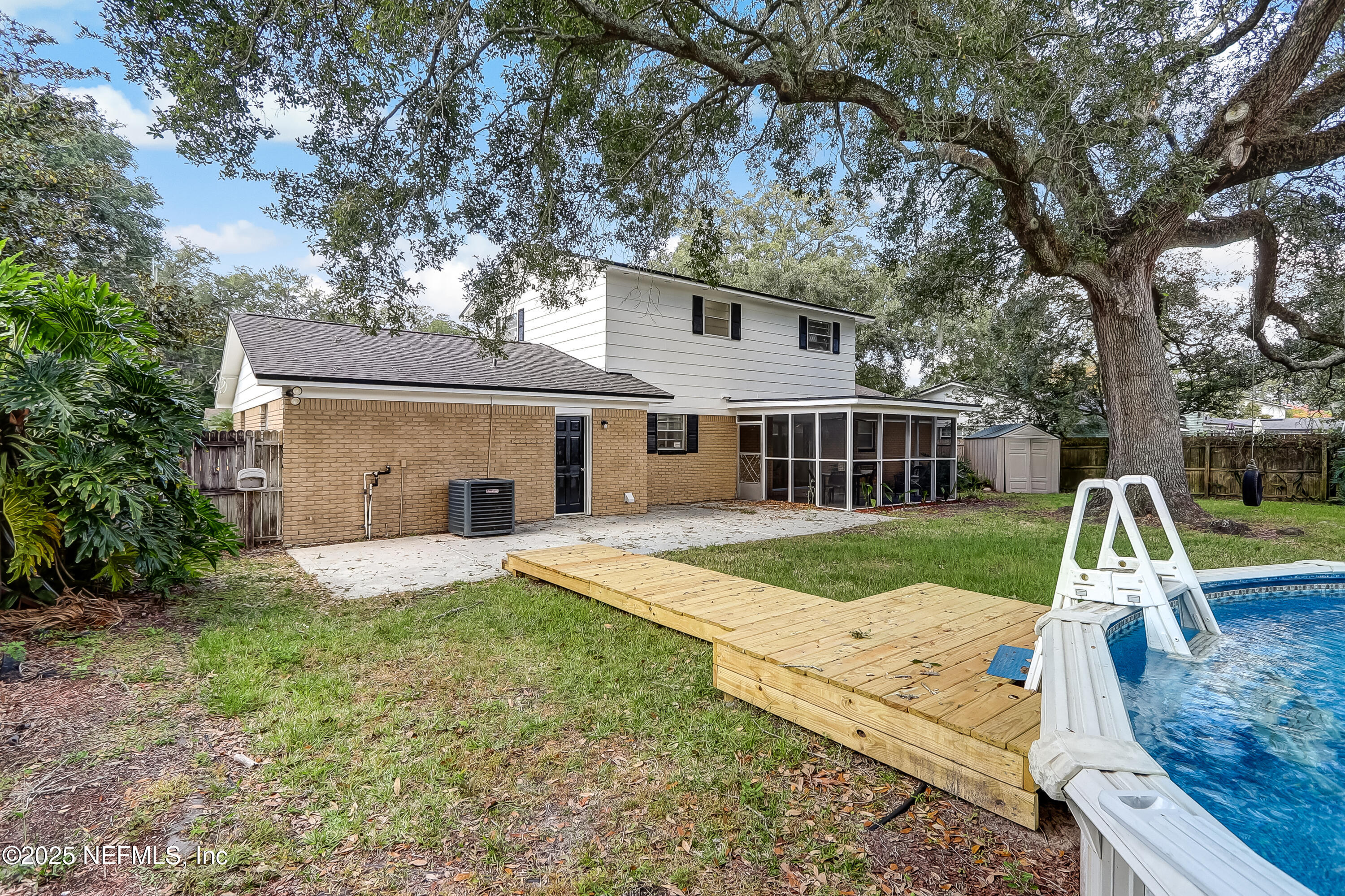 8837 Runnymeade Road Jacksonville, FL 32257 - Photo 53 of 55 a view of a house with a yard and large tree