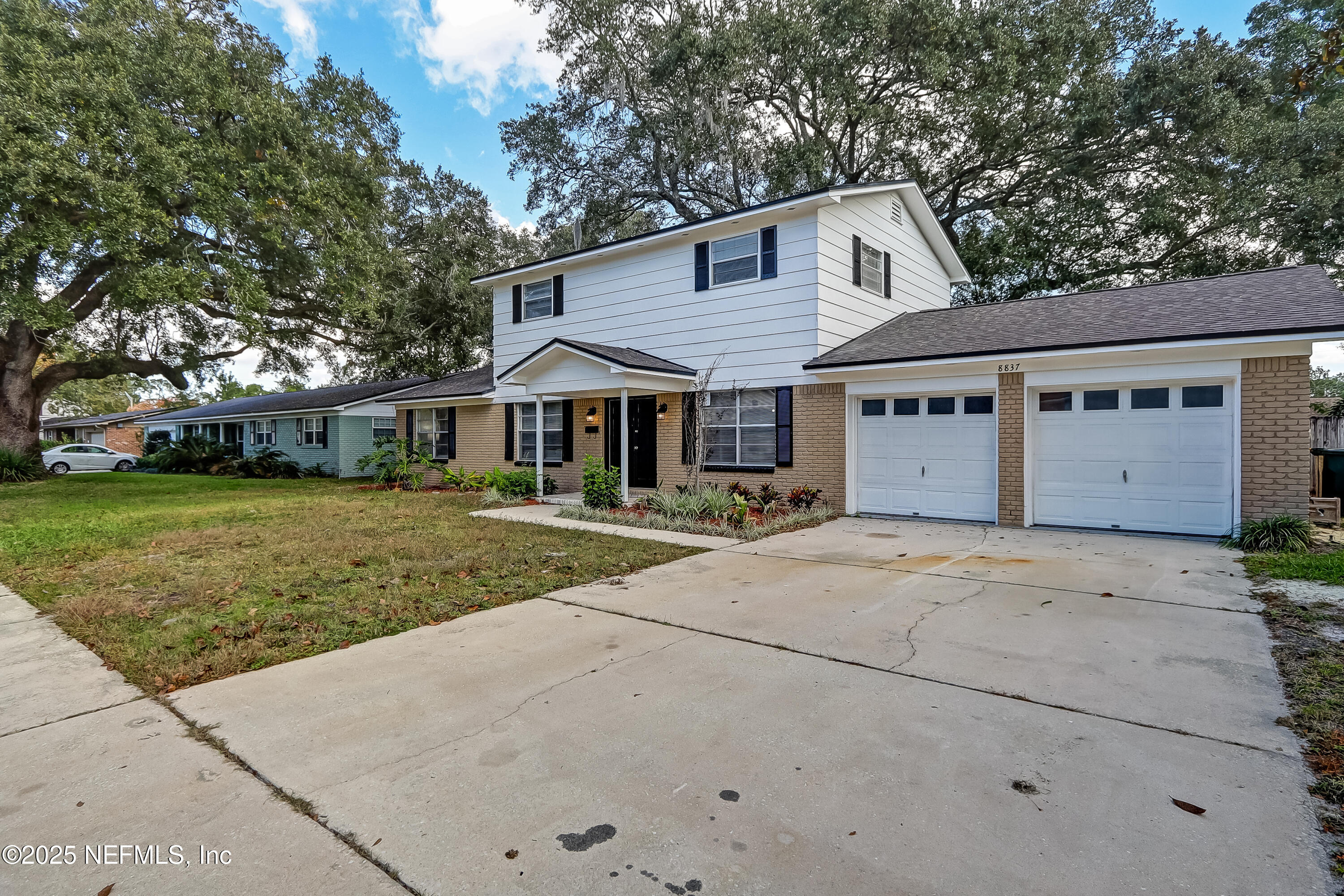 8837 Runnymeade Road Jacksonville, FL 32257 - Photo 6 of 55 a front view of a house with a yard and garage
