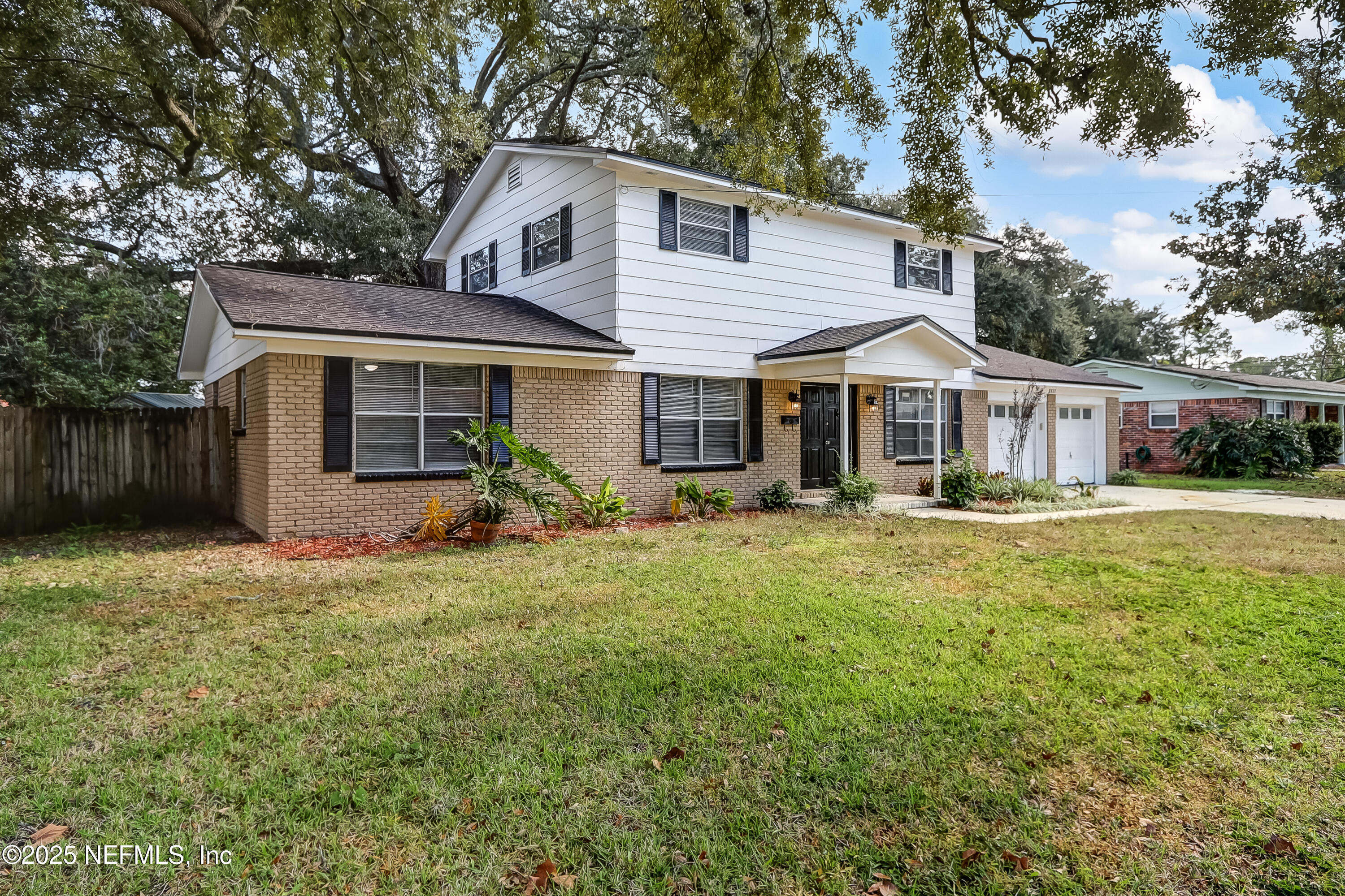 8837 Runnymeade Road Jacksonville, FL 32257 - Photo 7 of 55 a front view of a house with a garden