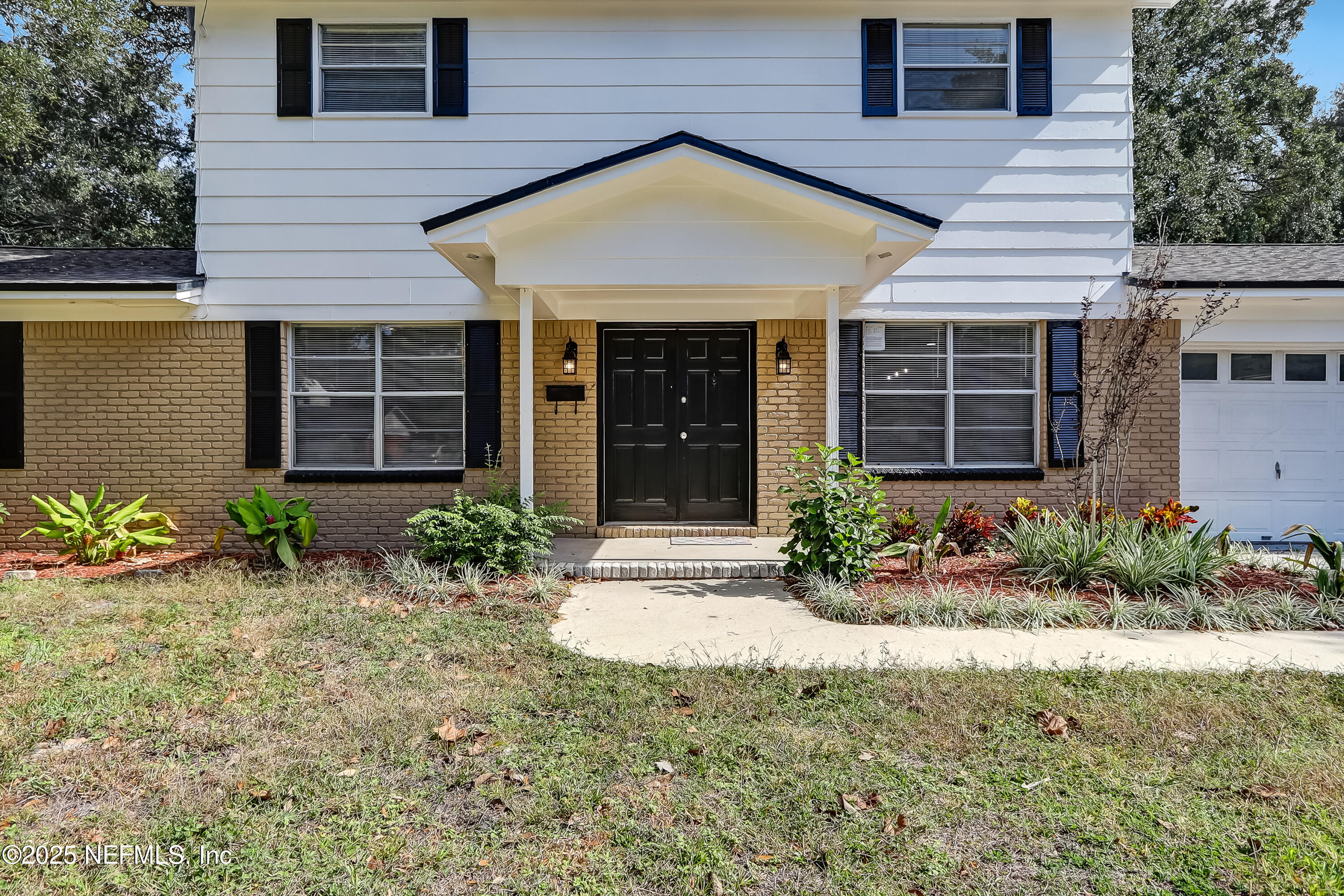 8837 Runnymeade Road Jacksonville, FL 32257 - Photo 8 of 55 a front view of a house with garden