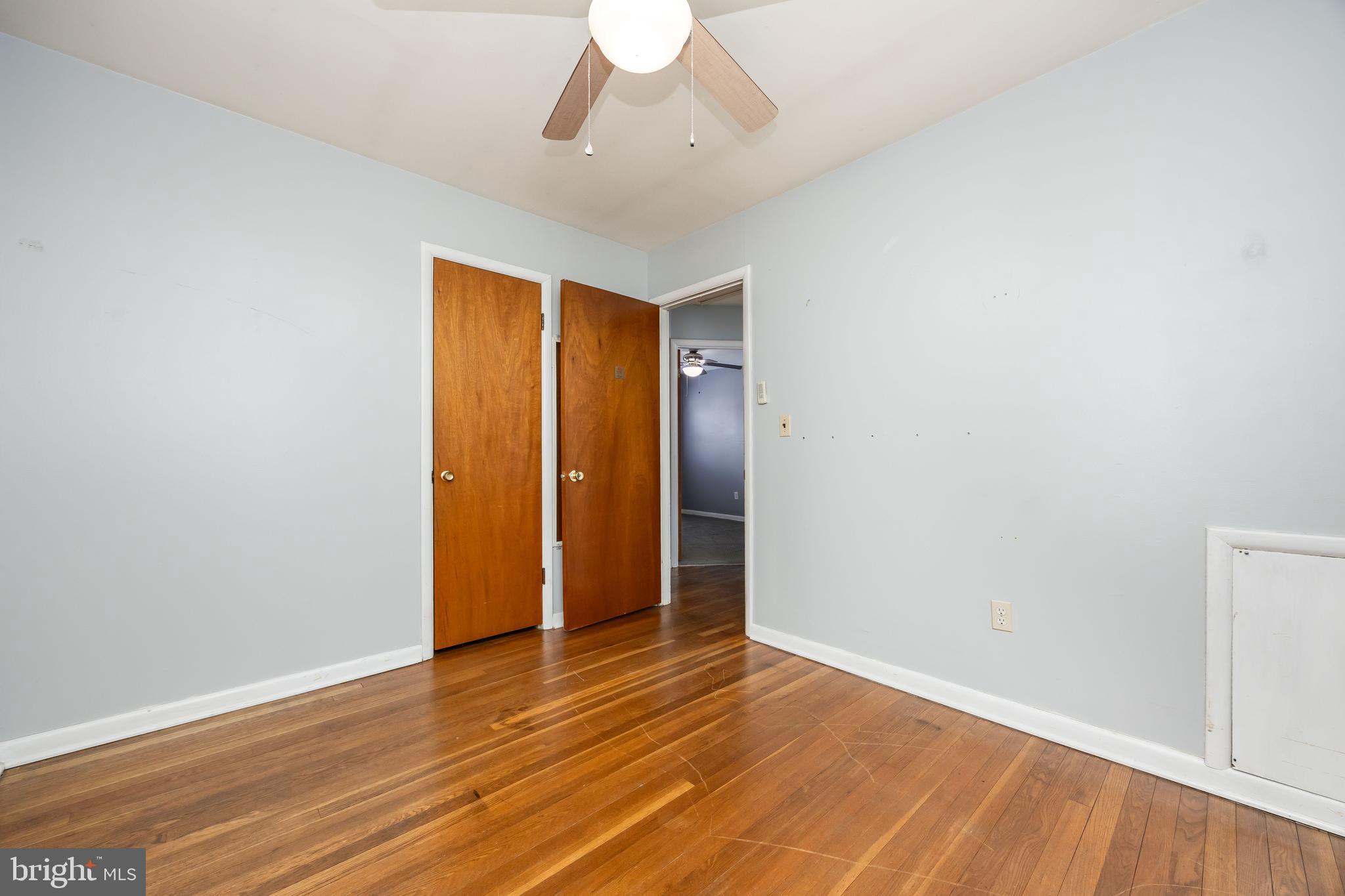 310 Zion Road Salisbury, MD 21804 - Photo 17 of 40 an empty room with wooden floor and ceiling fan