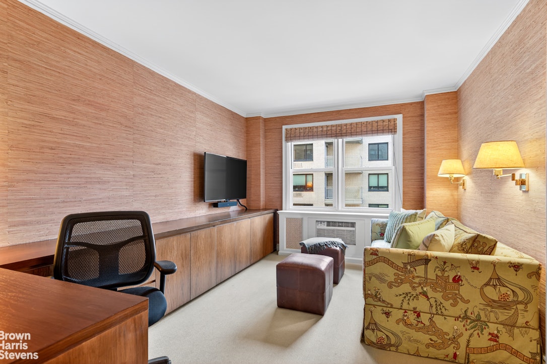 167 East 67th Street, Unit 8A Manhattan, NY 10065 - Photo 12 of 19 a living room with furniture and a flat screen tv