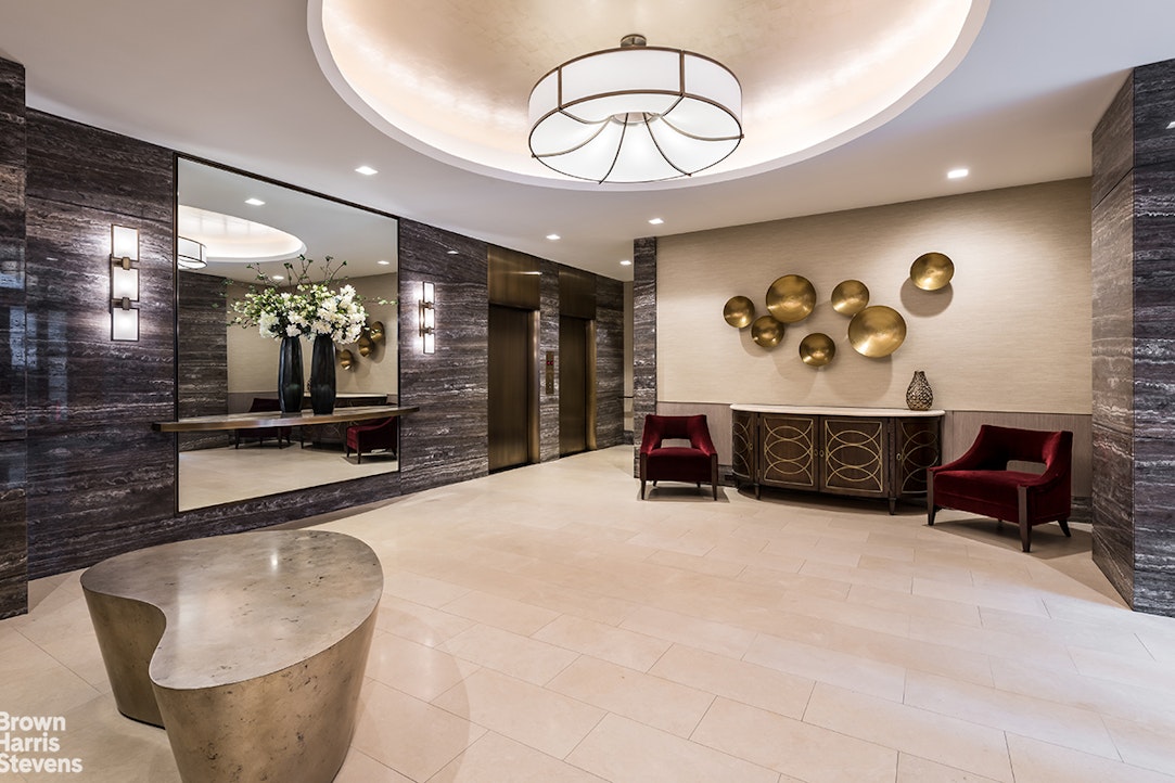 167 East 67th Street, Unit 8A Manhattan, NY 10065 - Photo 17 of 19 a living room with furniture and a chandelier