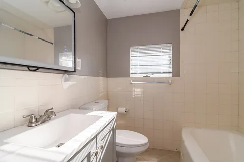 a bathroom with a sink a toilet and a bathtub