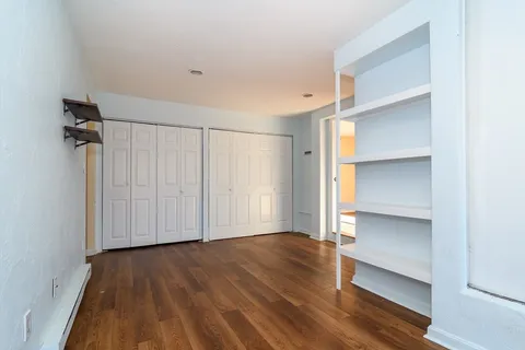 a view of an empty room with a closet