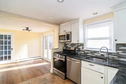 a kitchen with stainless steel appliances a sink stove and microwave