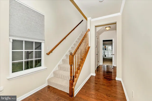 a view of staircase with wooden floor and a window