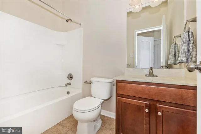a living room with furniture a chandelier and a table