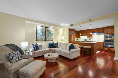 a kitchen with kitchen island granite countertop a sink cabinets and stainless steel appliances