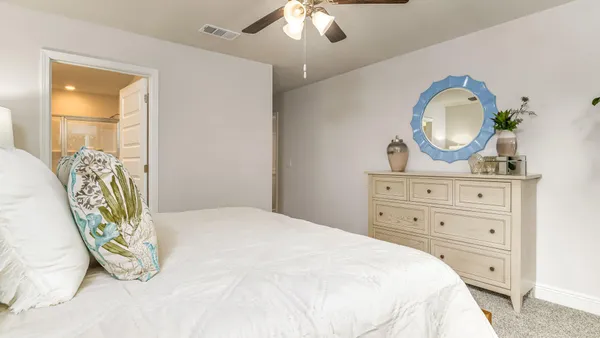 a bedroom with a bed and a dresser