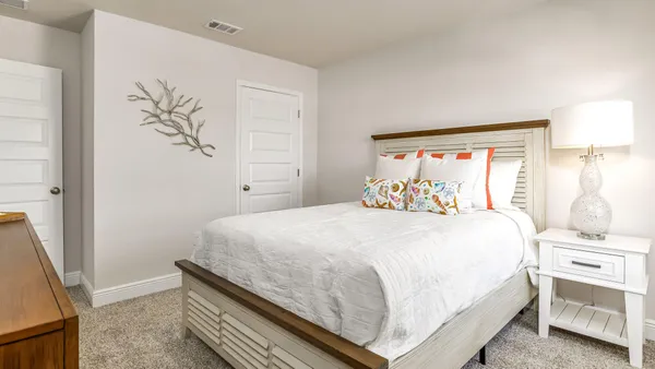 a bedroom with a large bed and a window