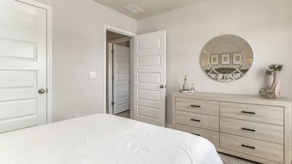 a bedroom with a bed and a dresser