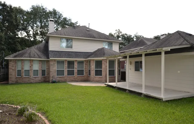 a view of a house with a garden and yard