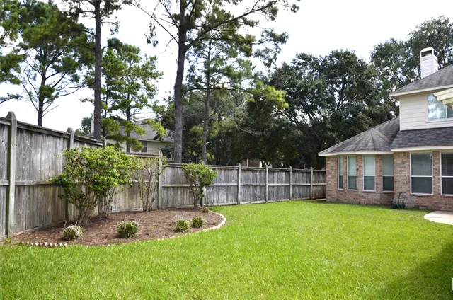 front view of a house with a yard and sitting area