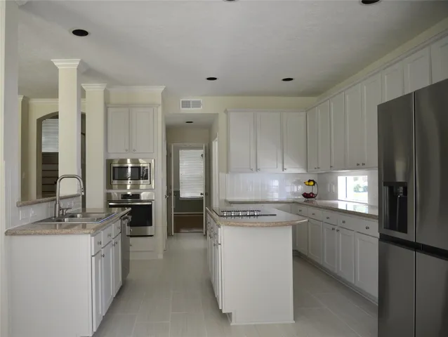 a kitchen with a refrigerator stove and sink