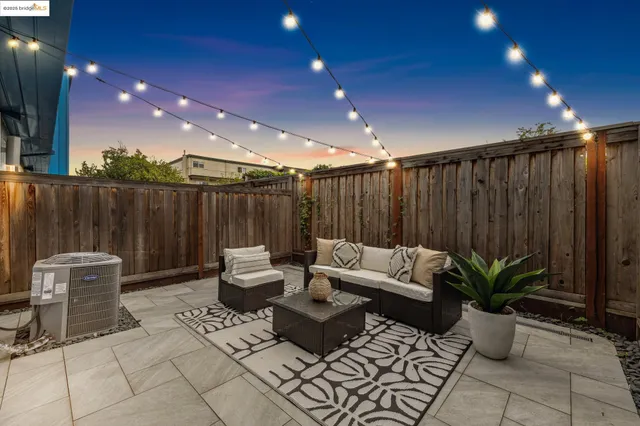 a patio with patio couch and potted plants