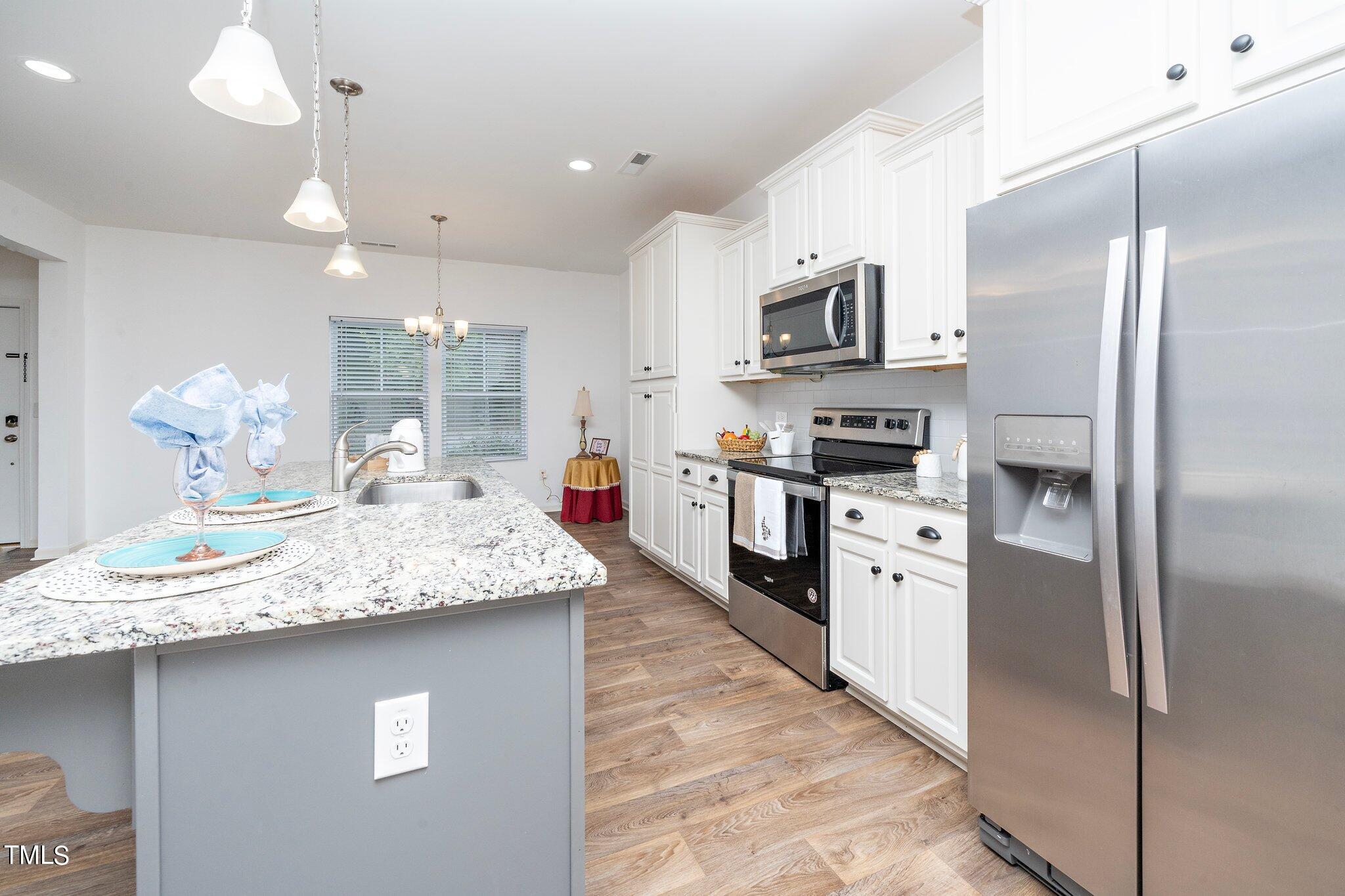 1060 North Gibson Road Mebane, NC 27302 - Photo 11 of 34 a kitchen with stainless steel appliances granite countertop a sink refrigerator and microwave