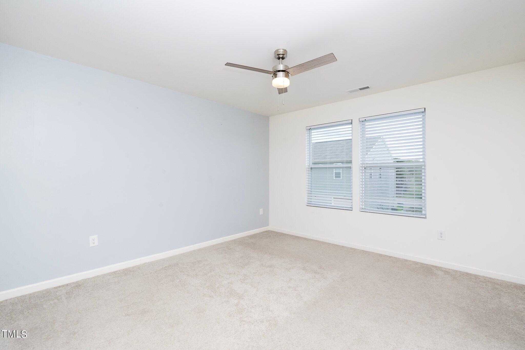 1060 North Gibson Road Mebane, NC 27302 - Photo 17 of 34 an empty room with a window and ceiling fan