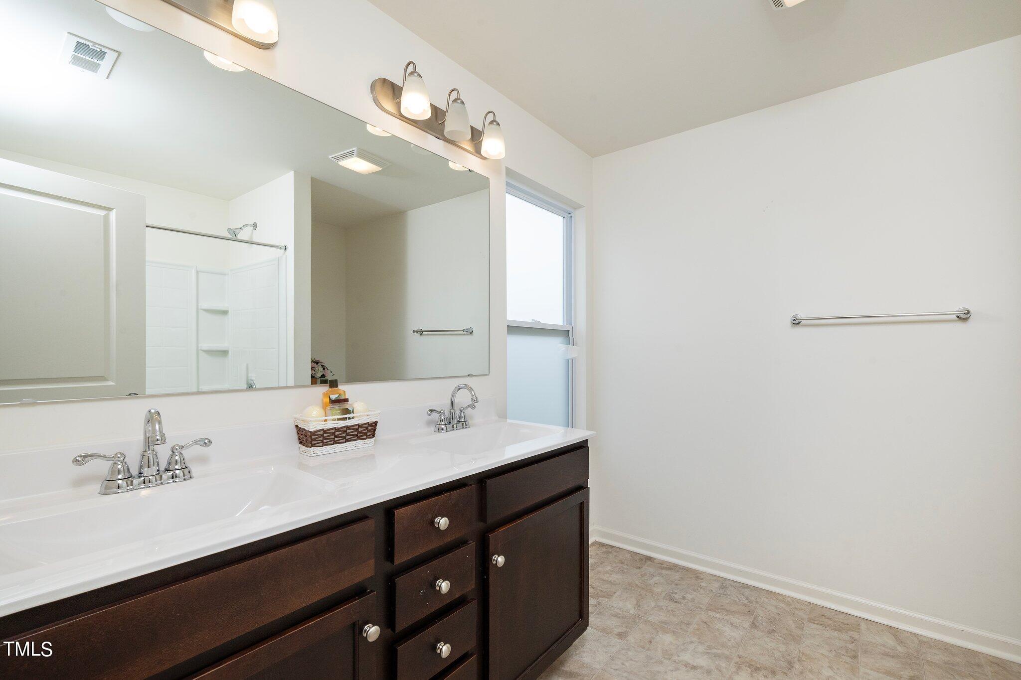 1060 North Gibson Road Mebane, NC 27302 - Photo 20 of 34 a bathroom with a sink double vanity and a mirror