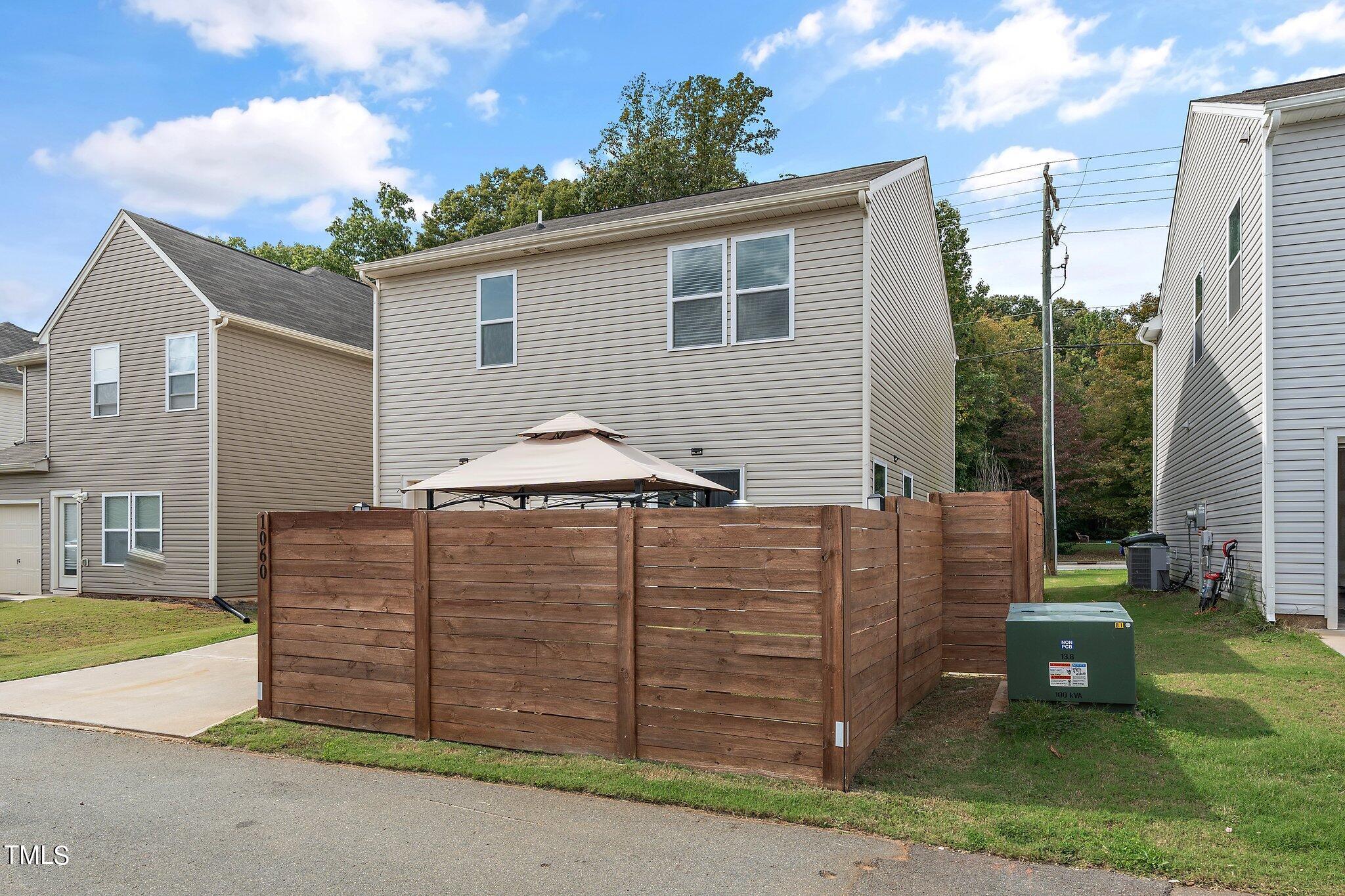 1060 North Gibson Road Mebane, NC 27302 - Photo 30 of 34 a view of a house with a small yard and wooden fence