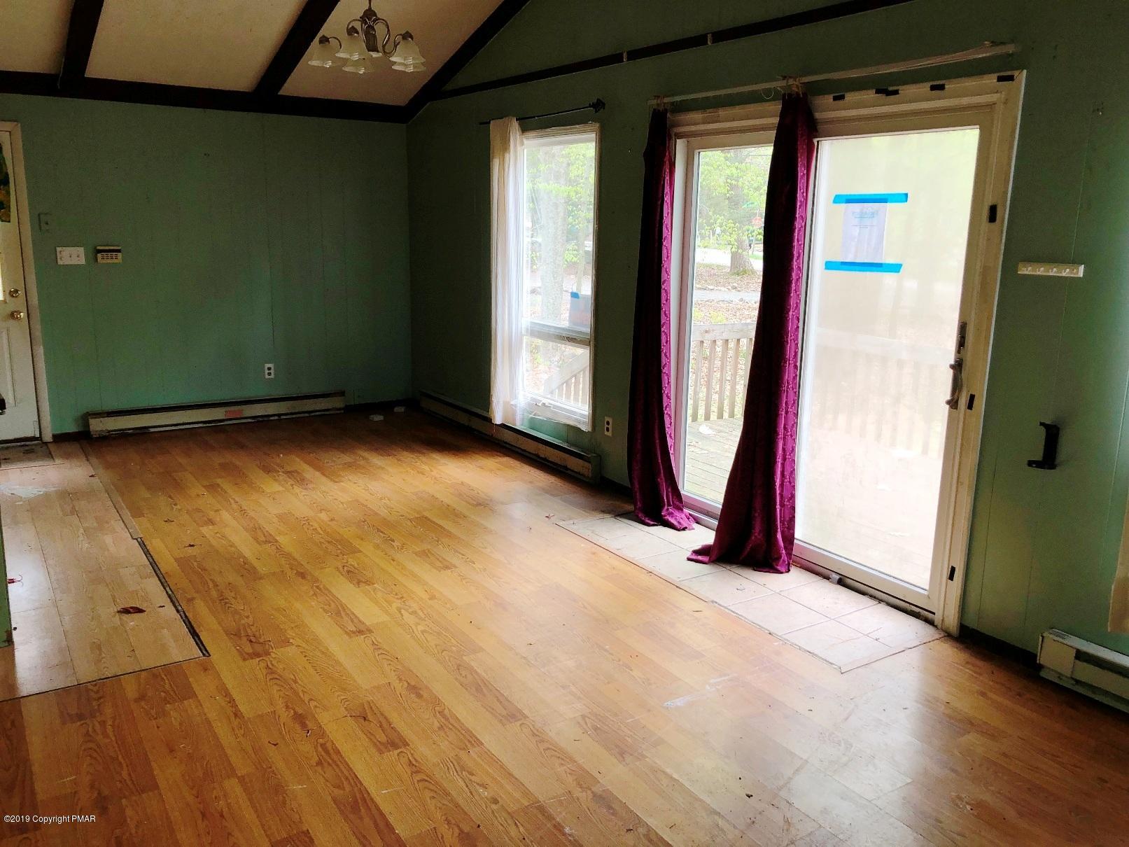 106 Elk Run Road Pocono Lake, PA 18347 - Photo 4 of 11 a view of an empty room with glass door