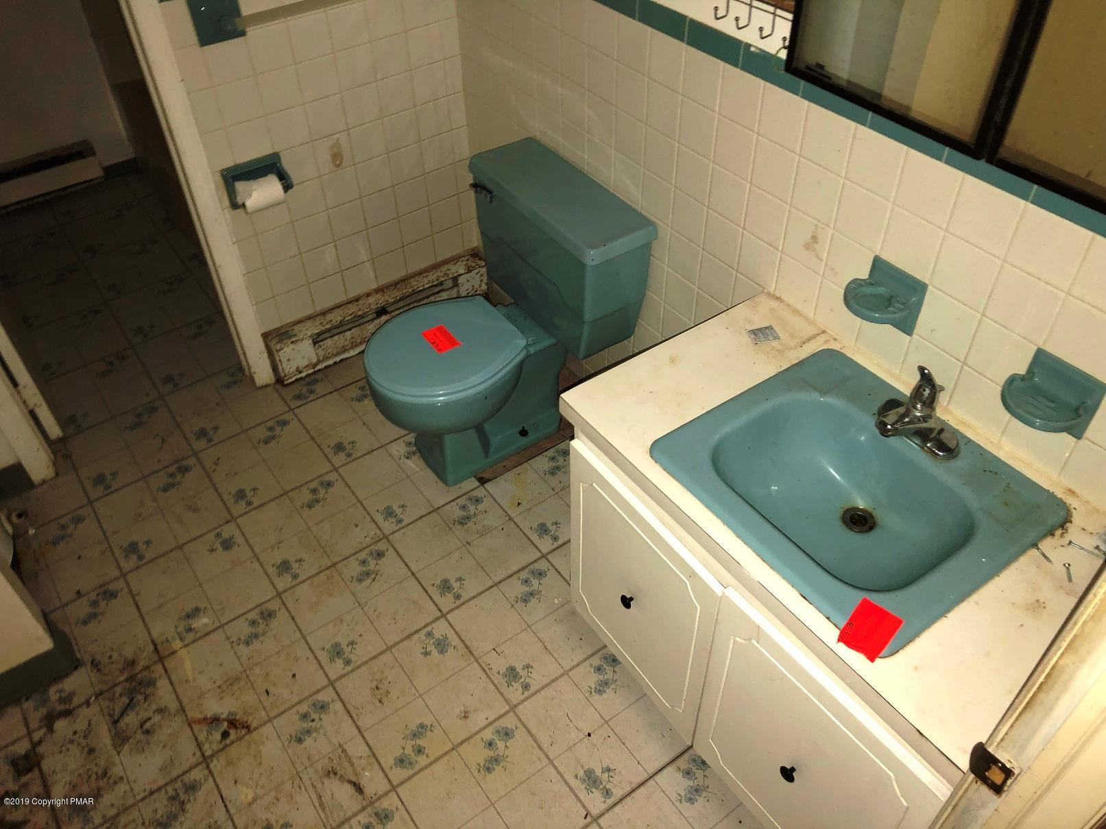 106 Elk Run Road Pocono Lake, PA 18347 - Photo 6 of 11 a bathroom with a sink and a mirror