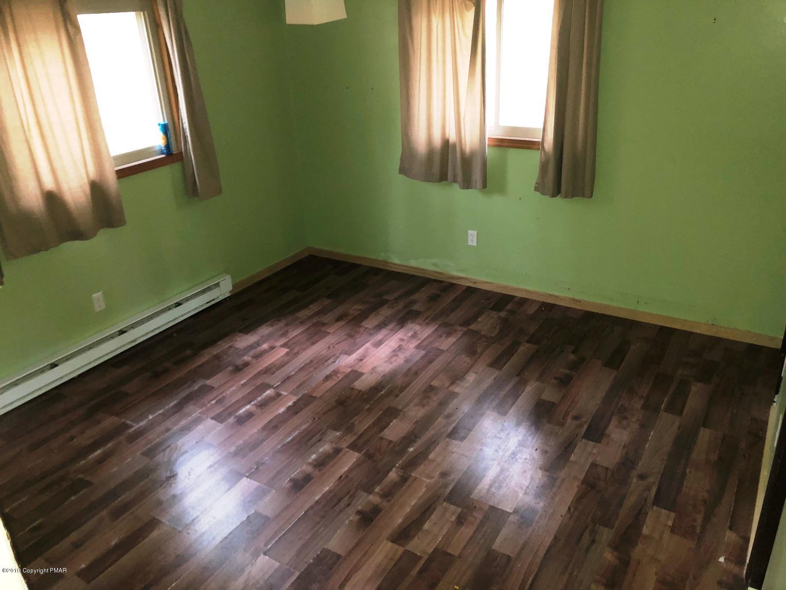 106 Elk Run Road Pocono Lake, PA 18347 - Photo 9 of 11 a view of a room with wooden floor and a window