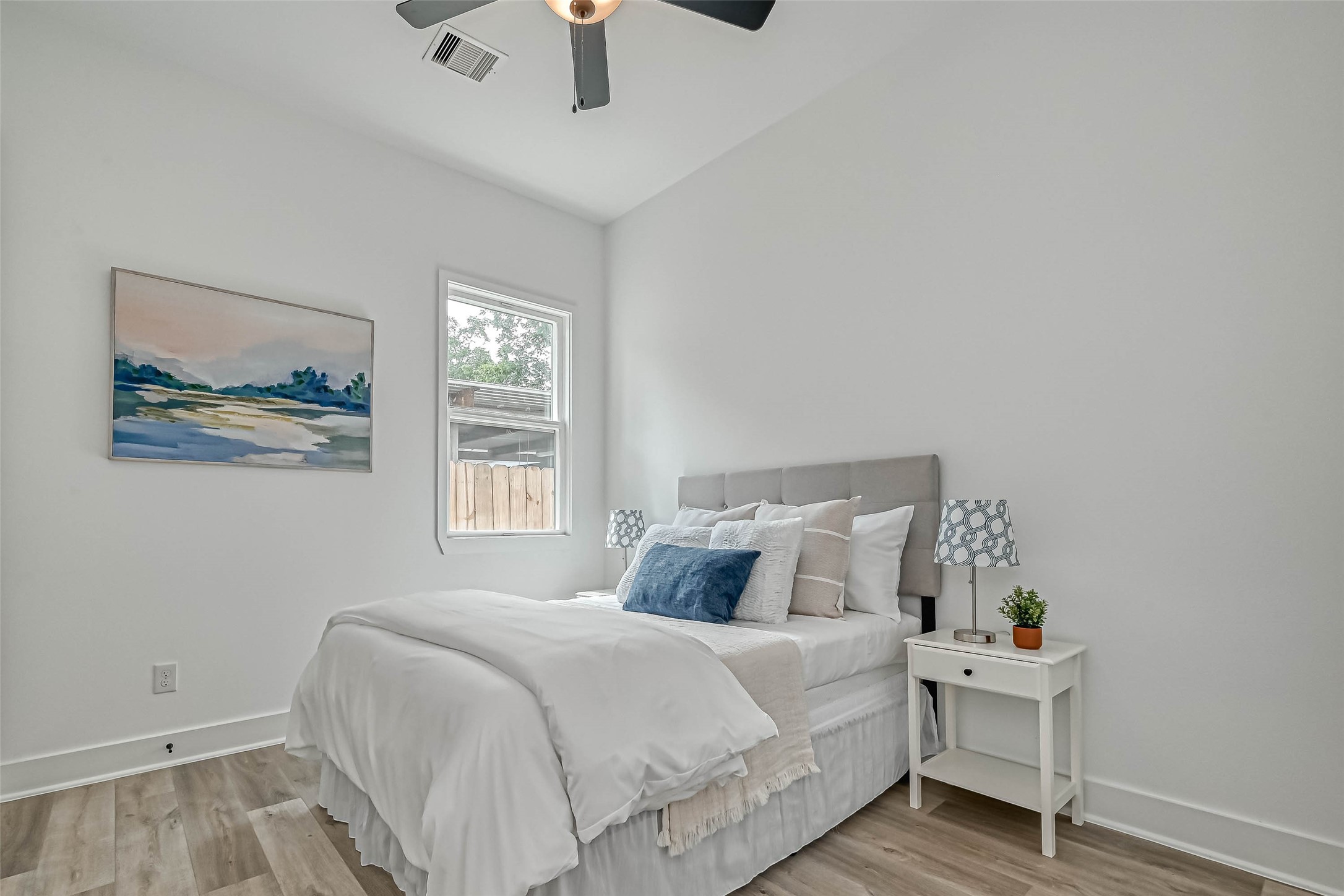 9316 Arledge Street, Unit B Houston, TX 77075 - Photo 11 of 26 a bedroom with a bed and a painting on the wall