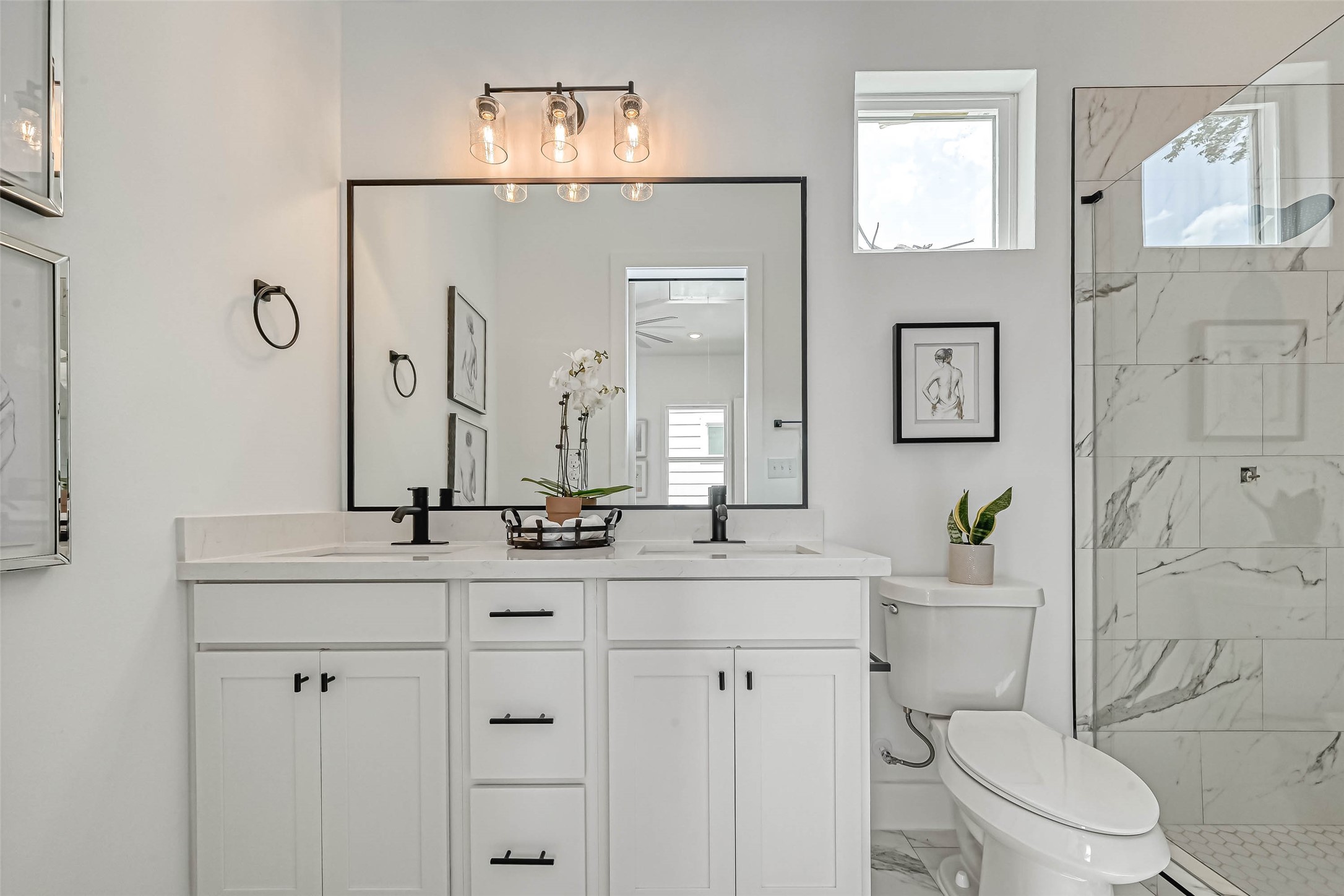 9316 Arledge Street, Unit B Houston, TX 77075 - Photo 17 of 26 a bathroom with a double vanity sink toilet and shower