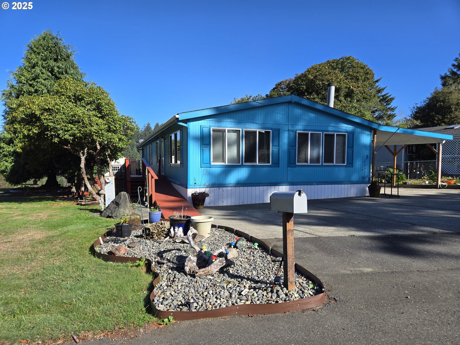 96465 Coverdell Road, Unit 8 Brookings, OR 97415 - Photo 2 of 42 a front view of a house with garden
