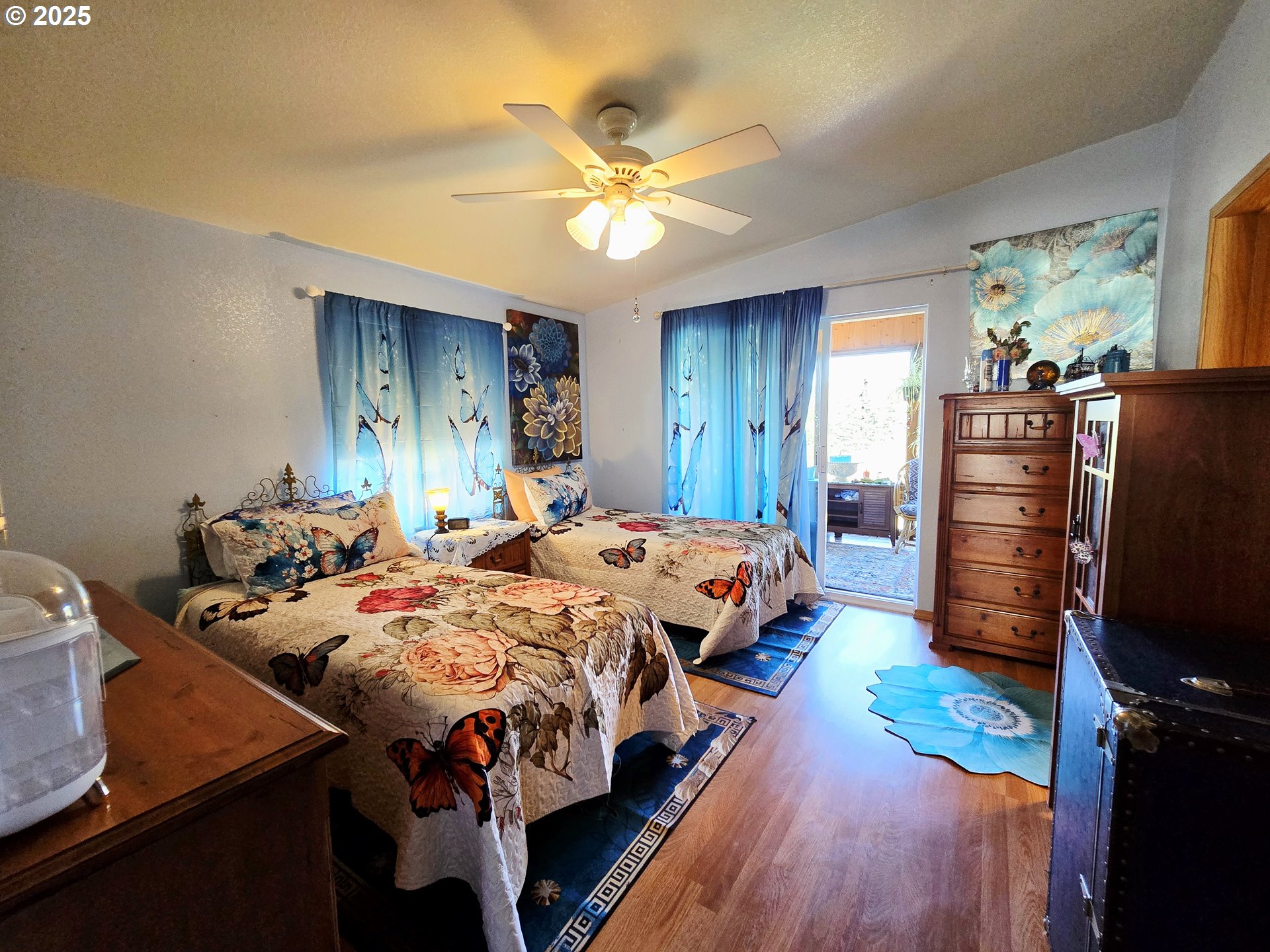 96465 Coverdell Road, Unit 8 Brookings, OR 97415 - Photo 25 of 42 a bed room with a bed and a ceiling fan