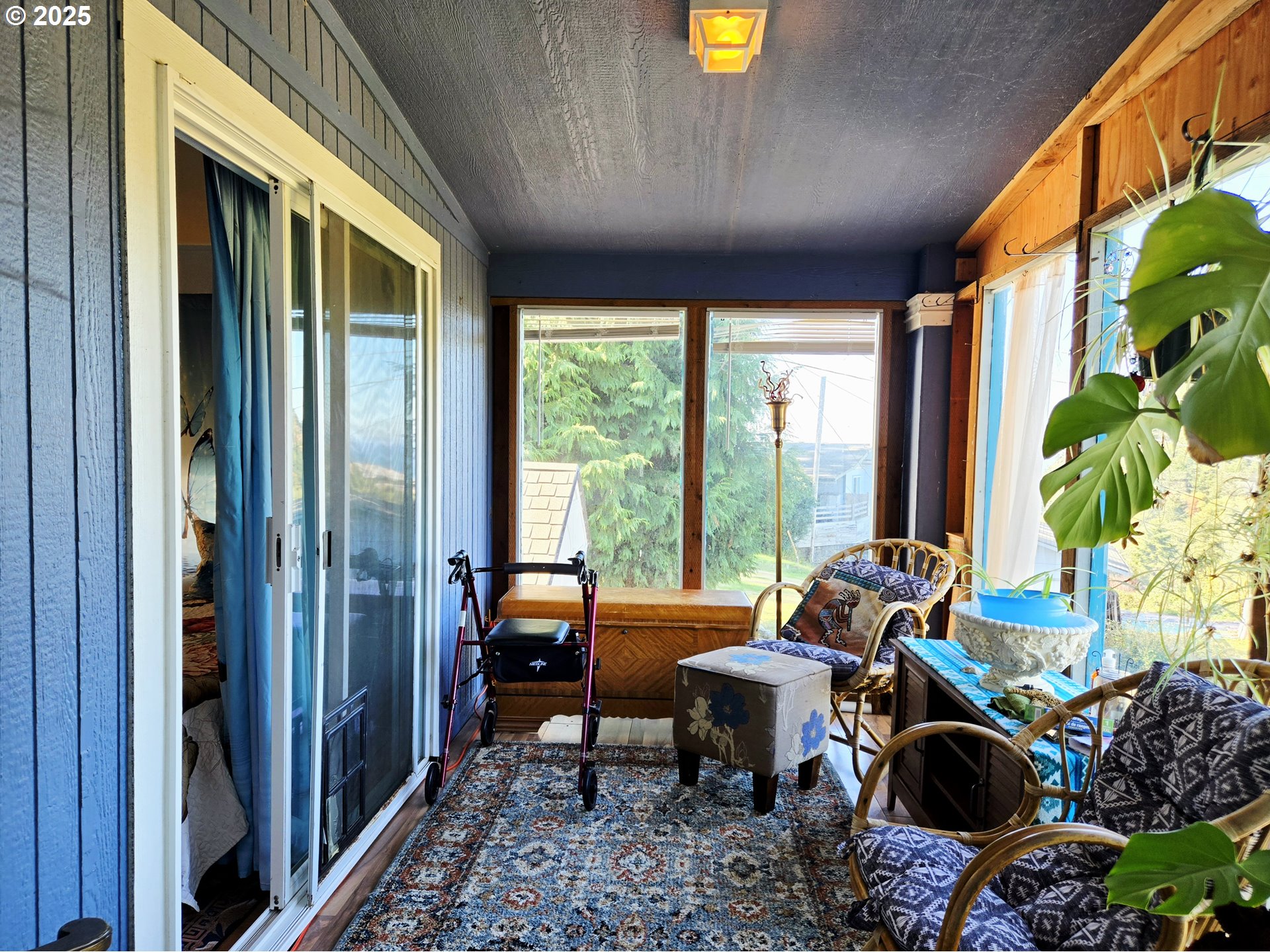 96465 Coverdell Road, Unit 8 Brookings, OR 97415 - Photo 34 of 42 a living room with furniture and a floor to ceiling window