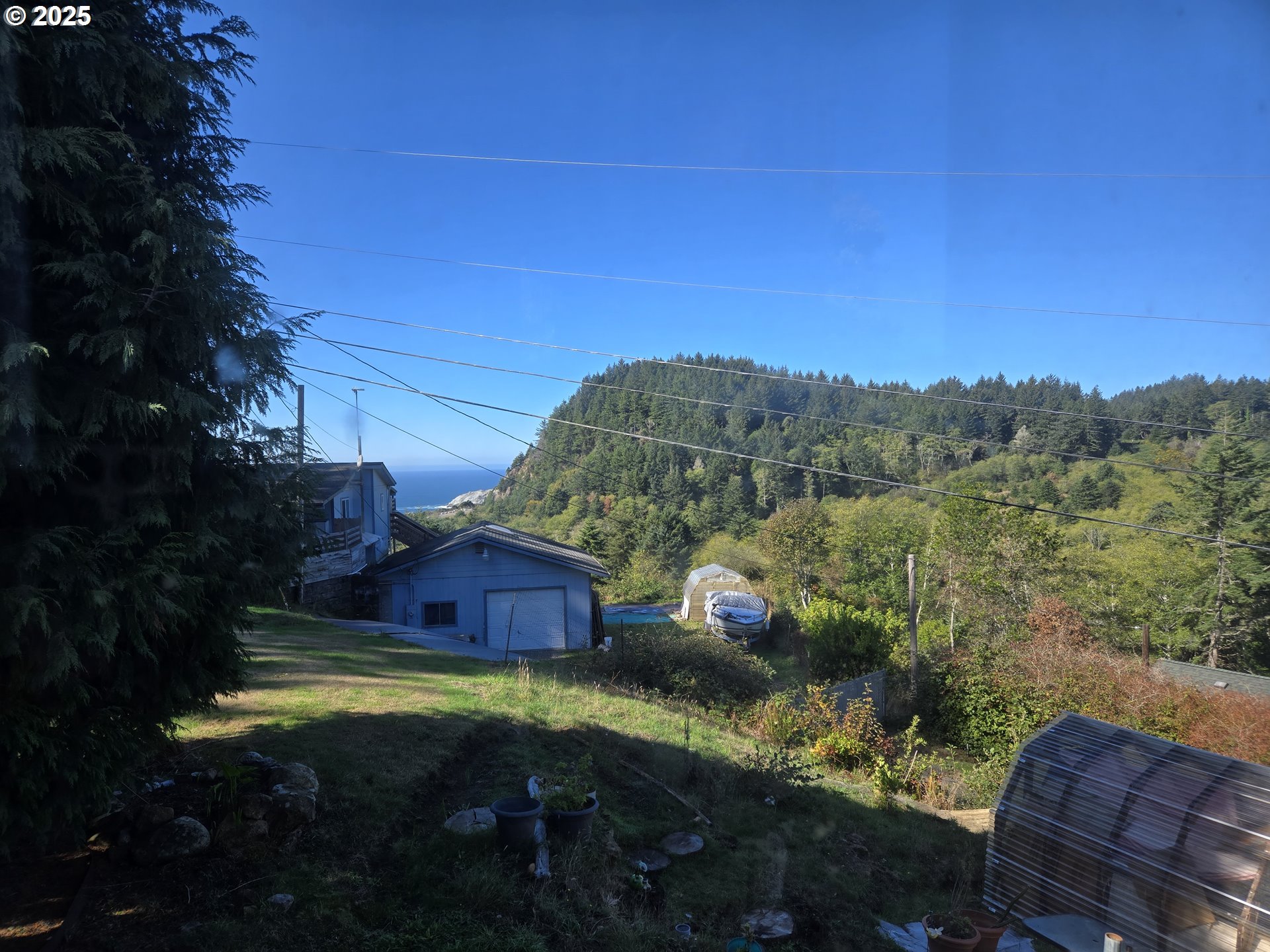 96465 Coverdell Road, Unit 8 Brookings, OR 97415 - Photo 35 of 42 a view of backyard with seating area and trees