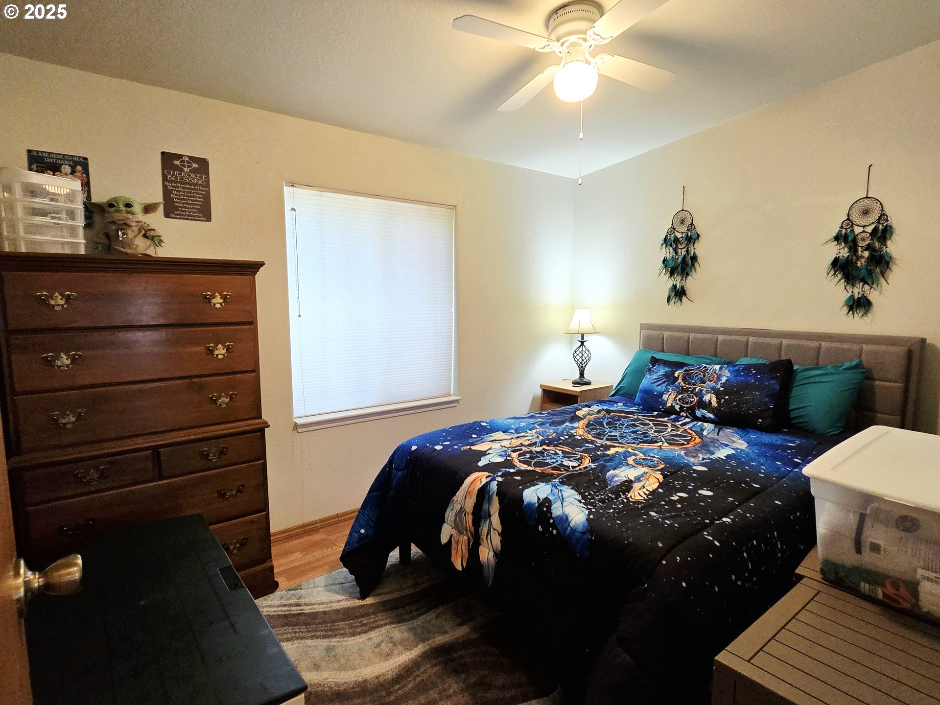 96465 Coverdell Road, Unit 8 Brookings, OR 97415 - Photo 40 of 42 a bedroom with a bed and a chandelier